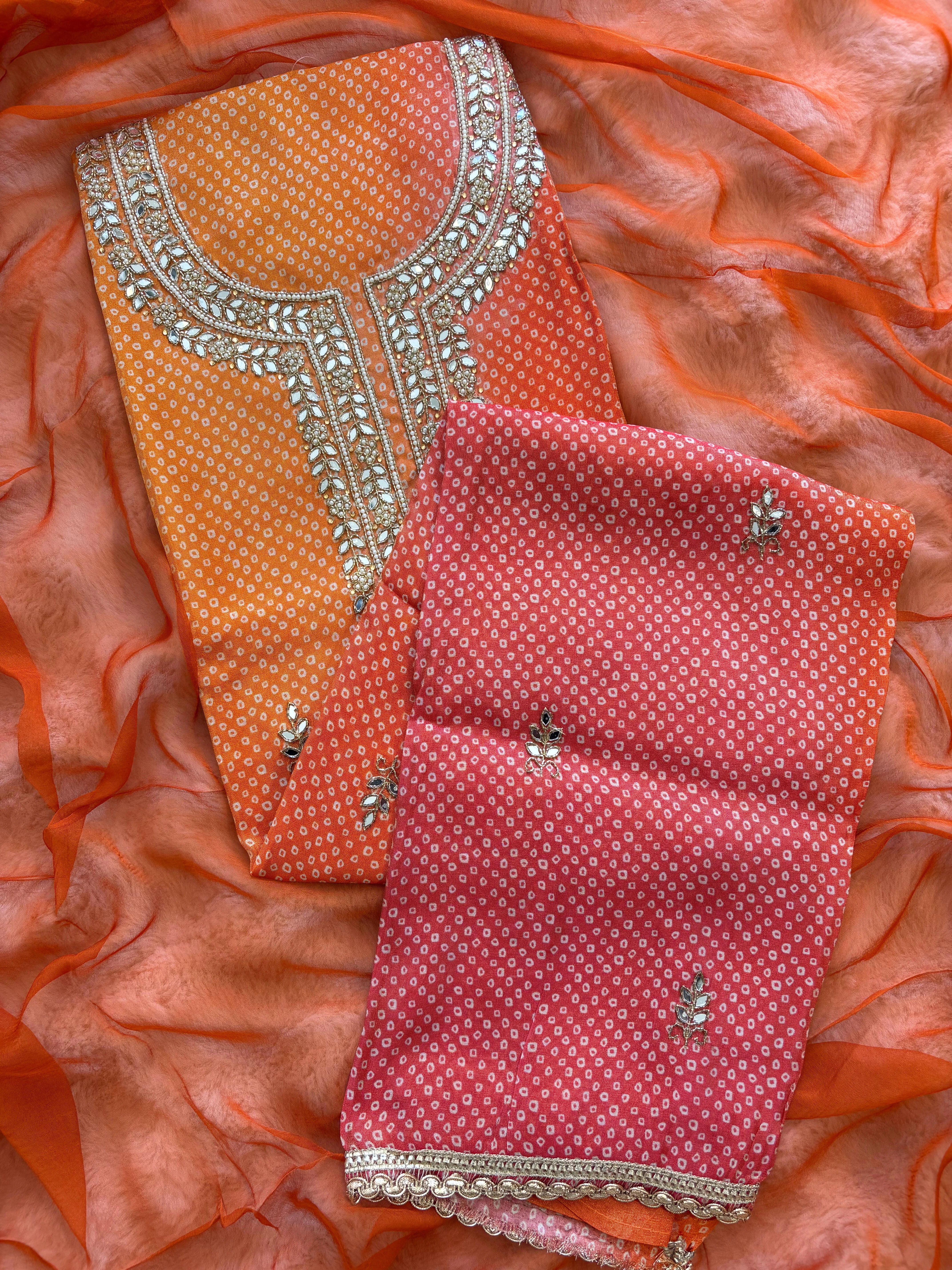 Orange Shimmer organza bandhani suit with ombre effect and chiffon dupatta with lace border.