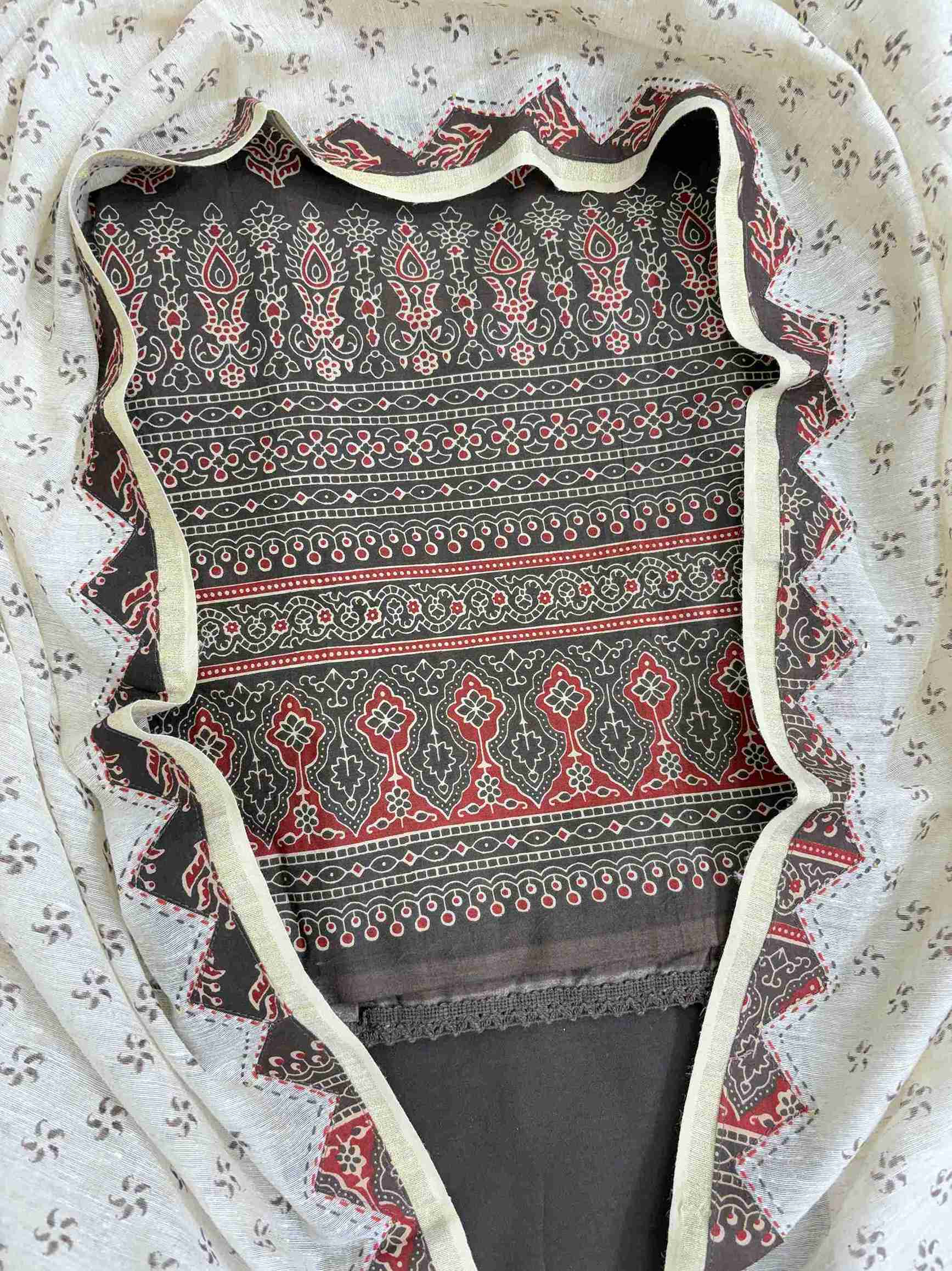 Dense ajrak-style multi-register printed daaman border in red cream and dark brown on pure cotton shirt