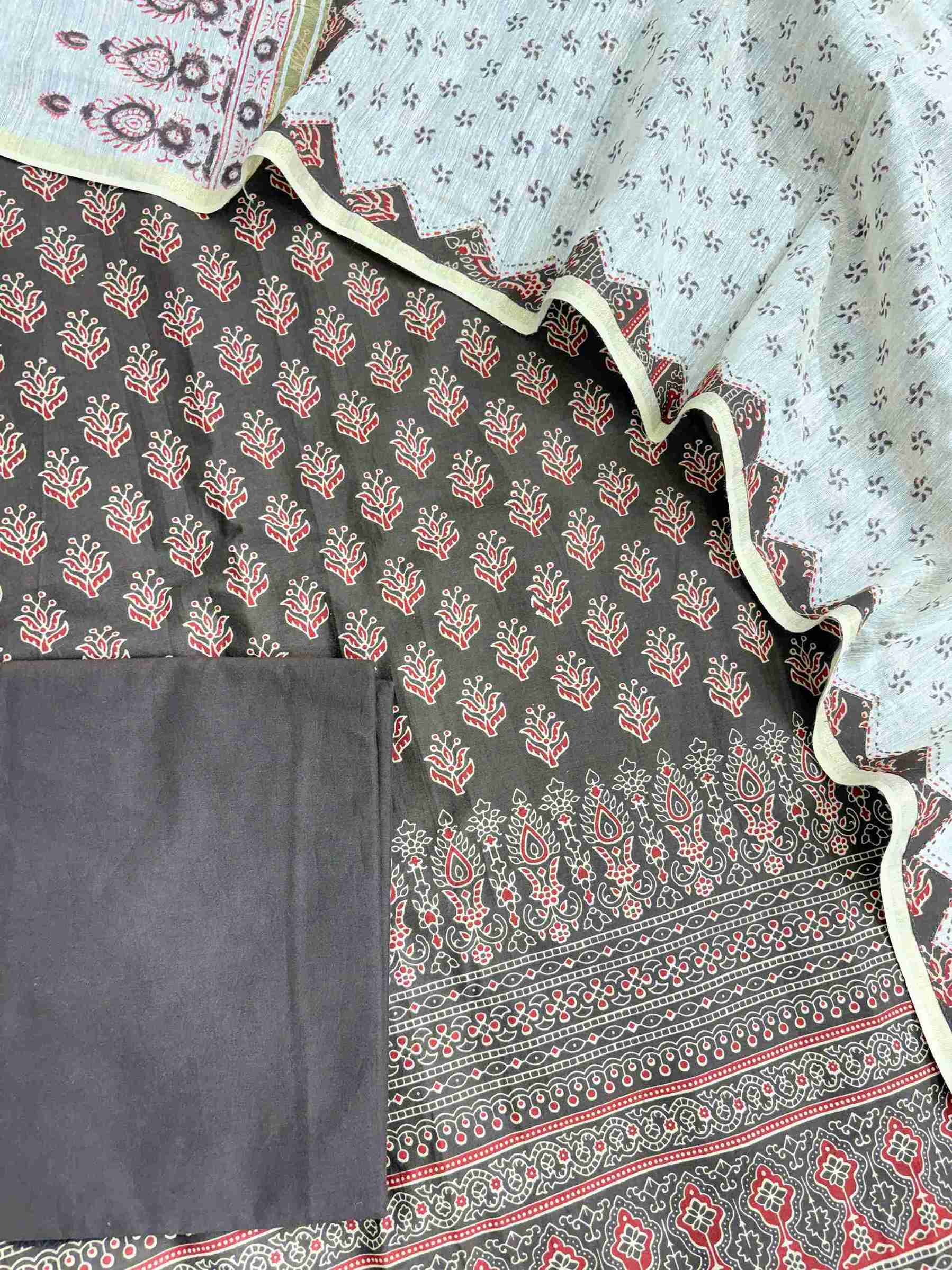 Complete dark brown pure cotton unstitched suit flat lay set with ajrak printed shirt, khadi dupatta, and matching cotton bottom