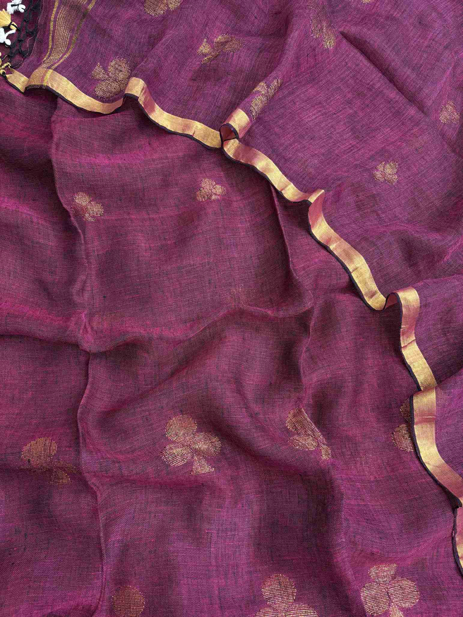 Scattered golden geometric spade woven motifs across deep magenta pure handloom linen dupatta surface