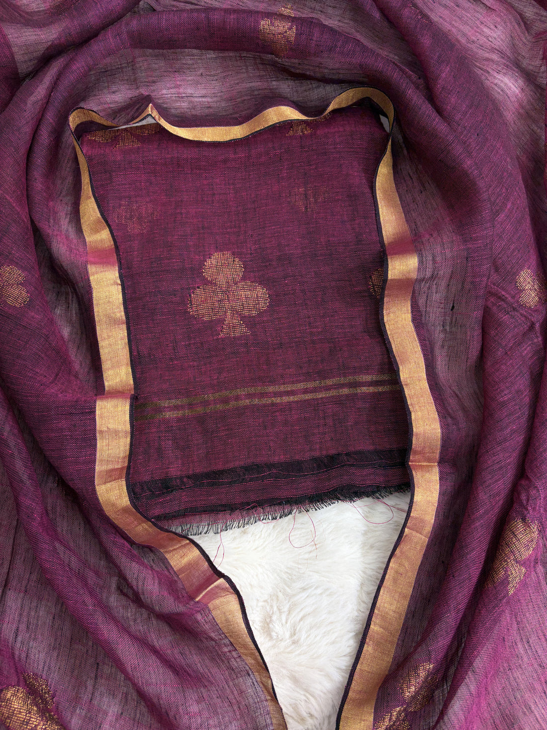 Natural slub texture and organic weave of deep magenta pure handloom linen shirt fabric close-up