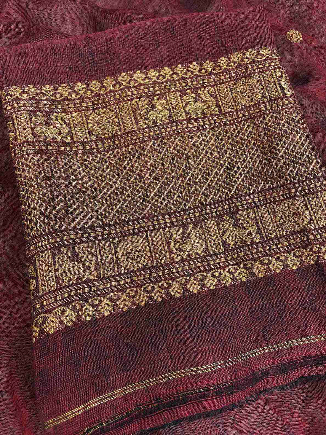 Scattered golden zari booties across the body of deep maroon jaishree linen unstitched shirt