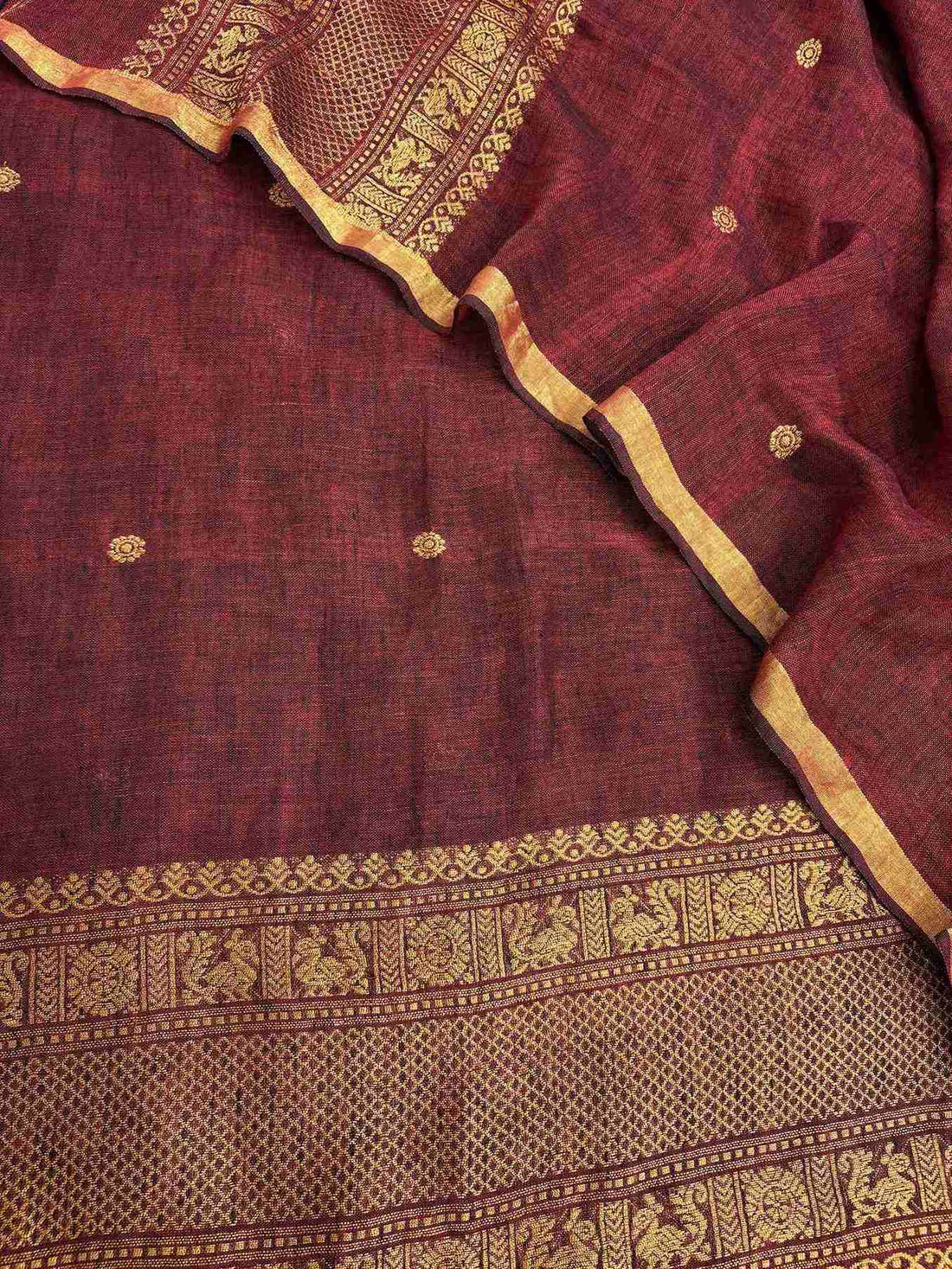 Complete deep maroon jaishree linen unstitched suit flat lay with shirt and dupatta showing zari booties and woven borders