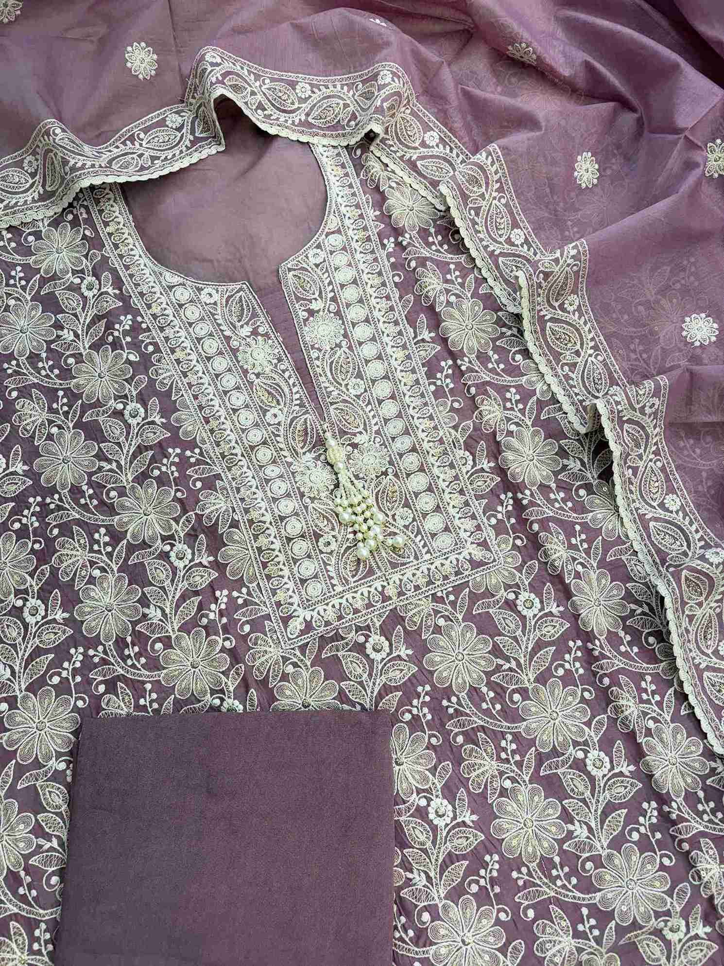 Detailed white resham thread embroidery with zari highlights on dusted mauve fabric