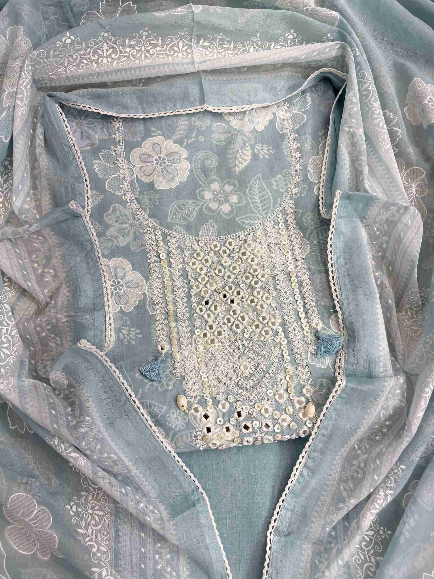 All-over white floral texture print detail across dusty blue cotton shirt body