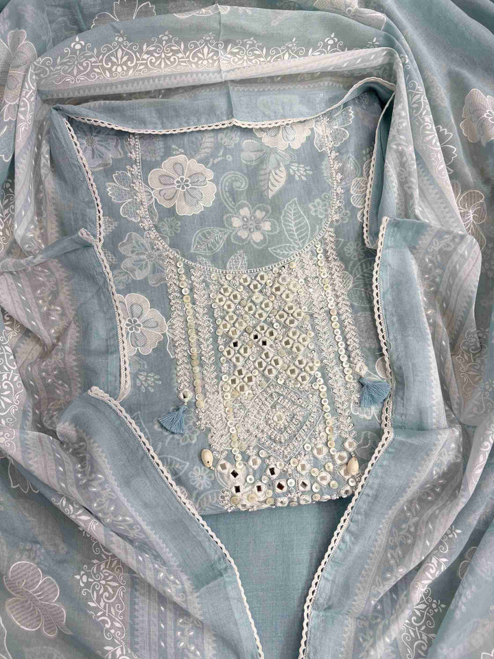 All-over white floral texture print detail across dusty blue cotton shirt body