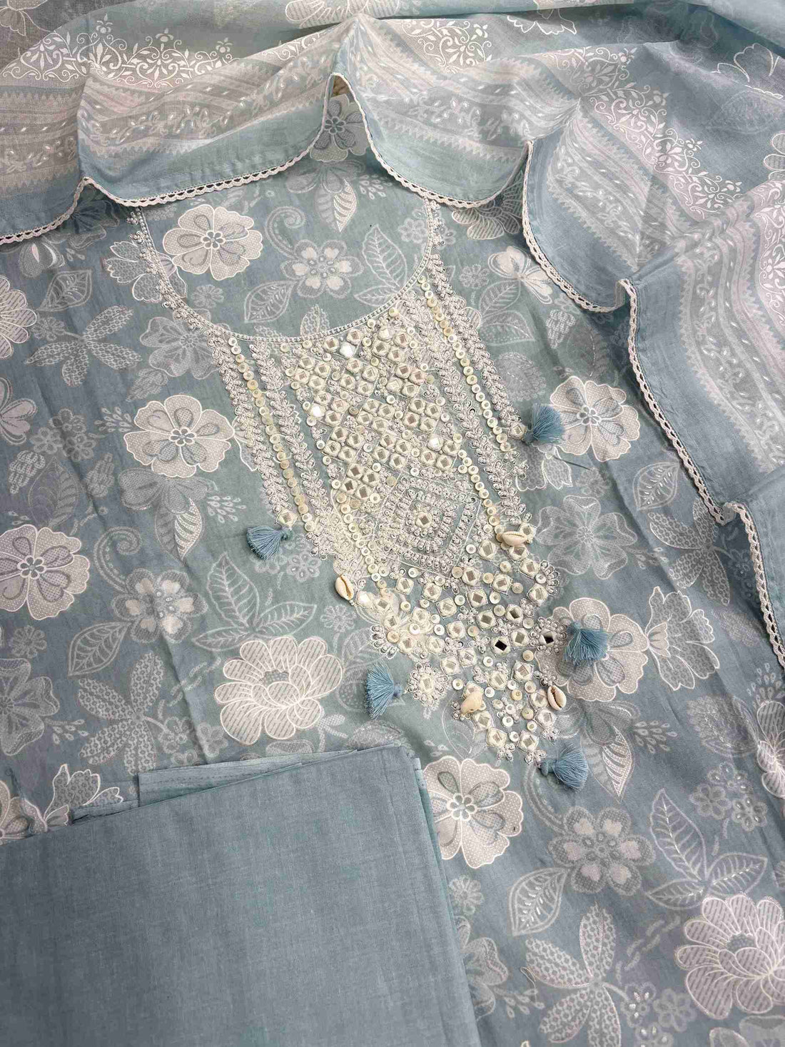 Complete dusty blue cotton unstitched suit flat lay set with floral printed shirt, dupatta, and matching cotton bottom