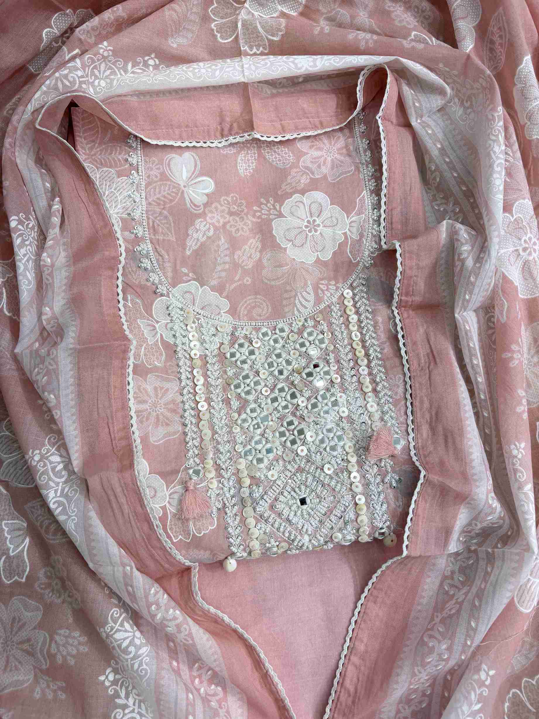 All-over white floral texture print detail across dusty pink cotton shirt body