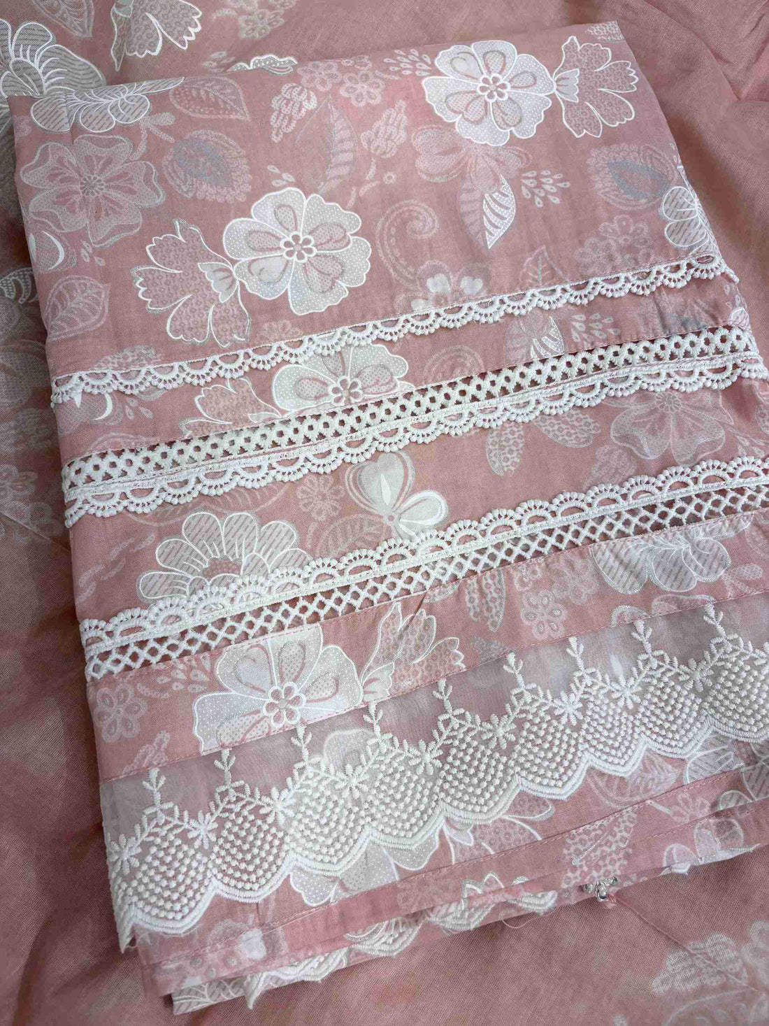 Multiple row crotia lace hemline finishing detail at the bottom of dusty pink cotton shirt