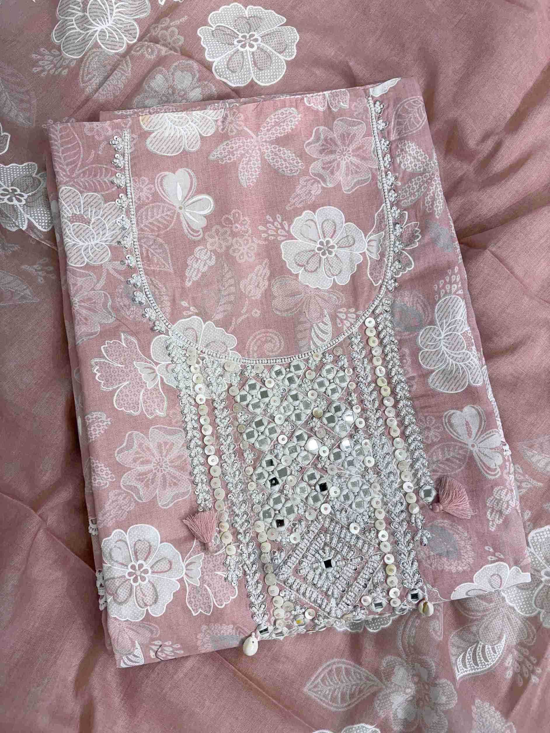 Close-up of mirror work, sequin and moti embellished neckline panel with tassels on dusty pink cotton shirt