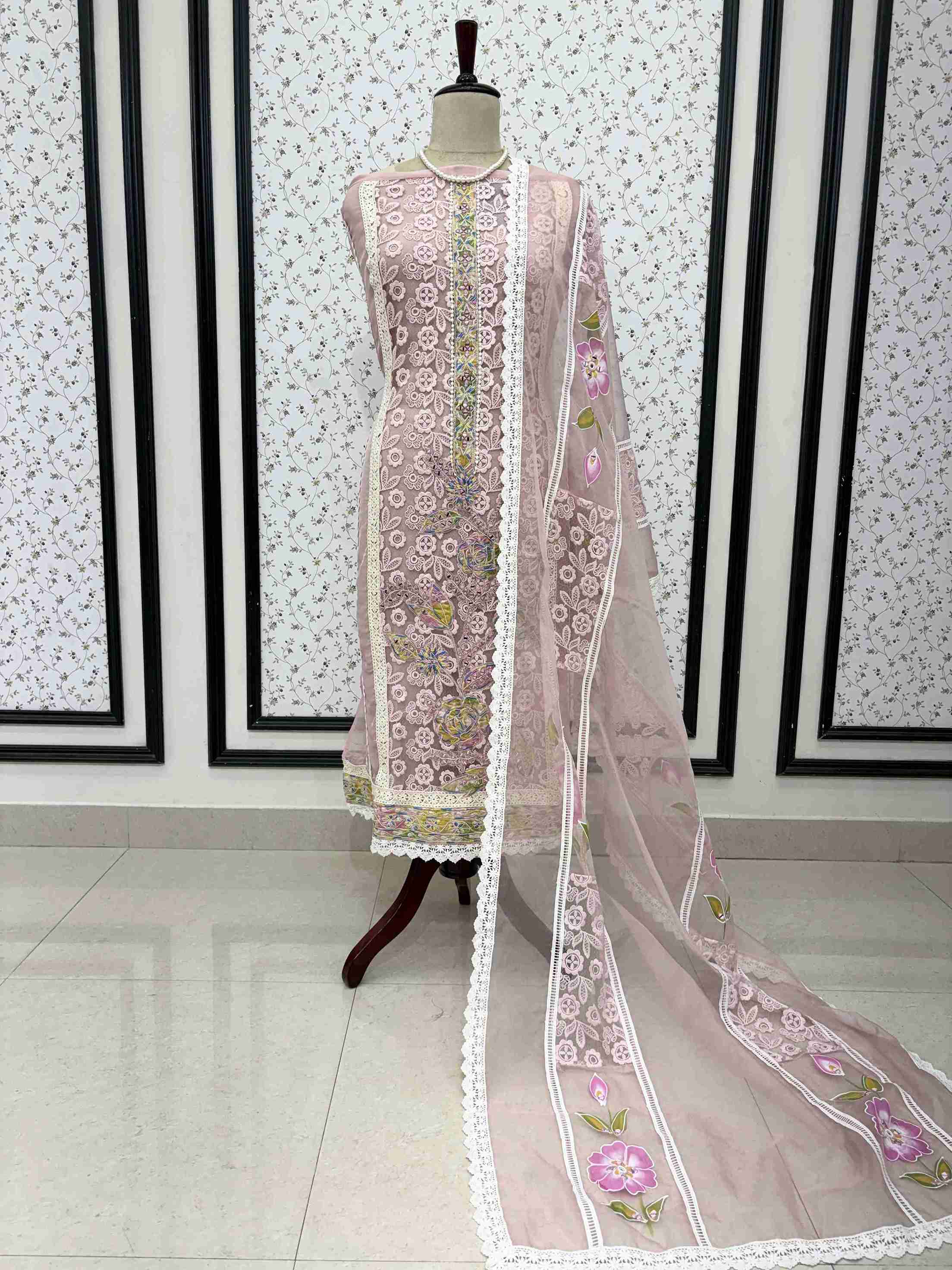 Dusty pink organza unstitched suit full front view with hand-painted floral dupatta draped on mannequin