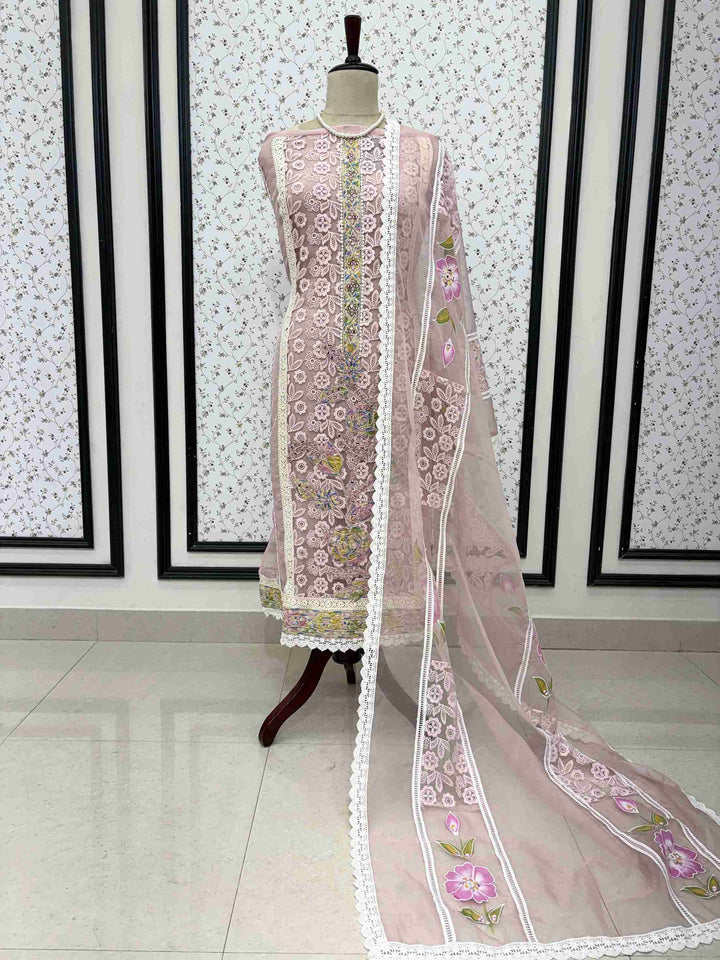 Dusty pink organza unstitched suit full front view with hand-painted floral dupatta draped on mannequin
