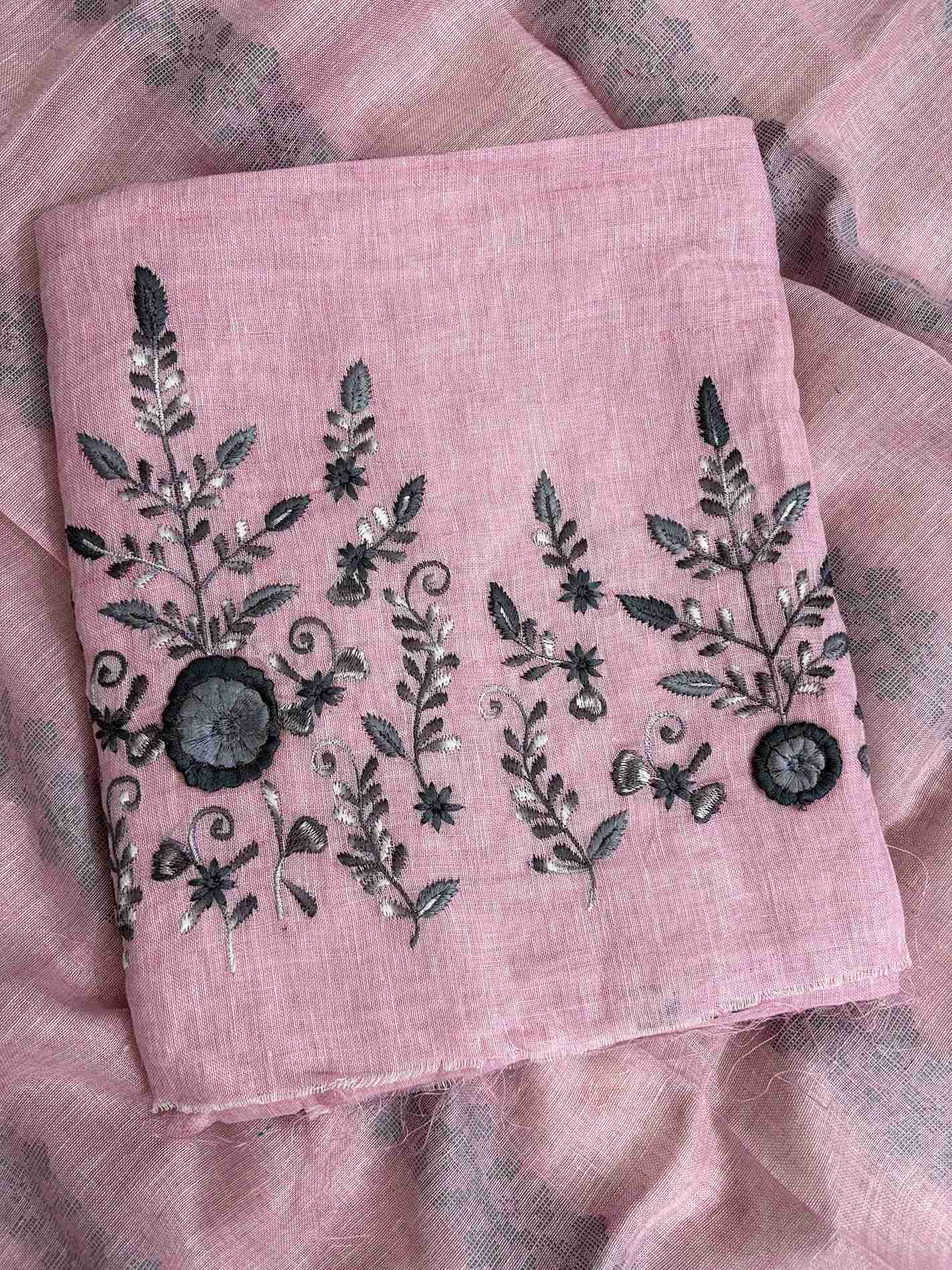 Scattered thread booties in contrasting colors across the body of dusty pink pure linen shirt
