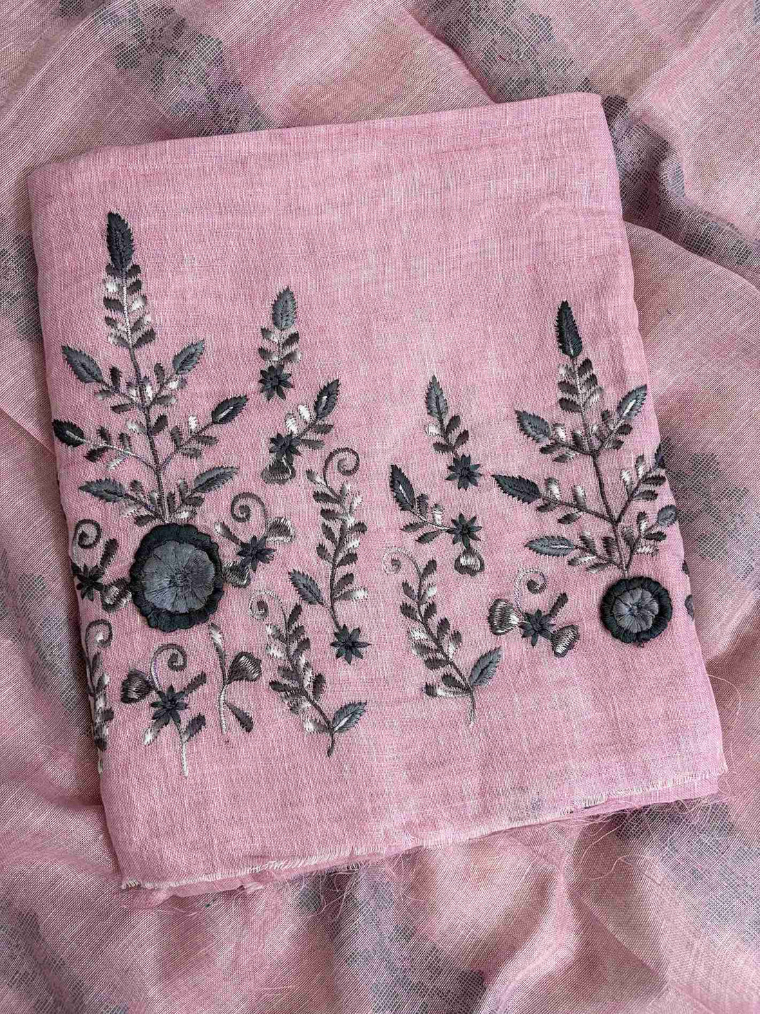 Scattered thread booties in contrasting colors across the body of dusty pink pure linen shirt