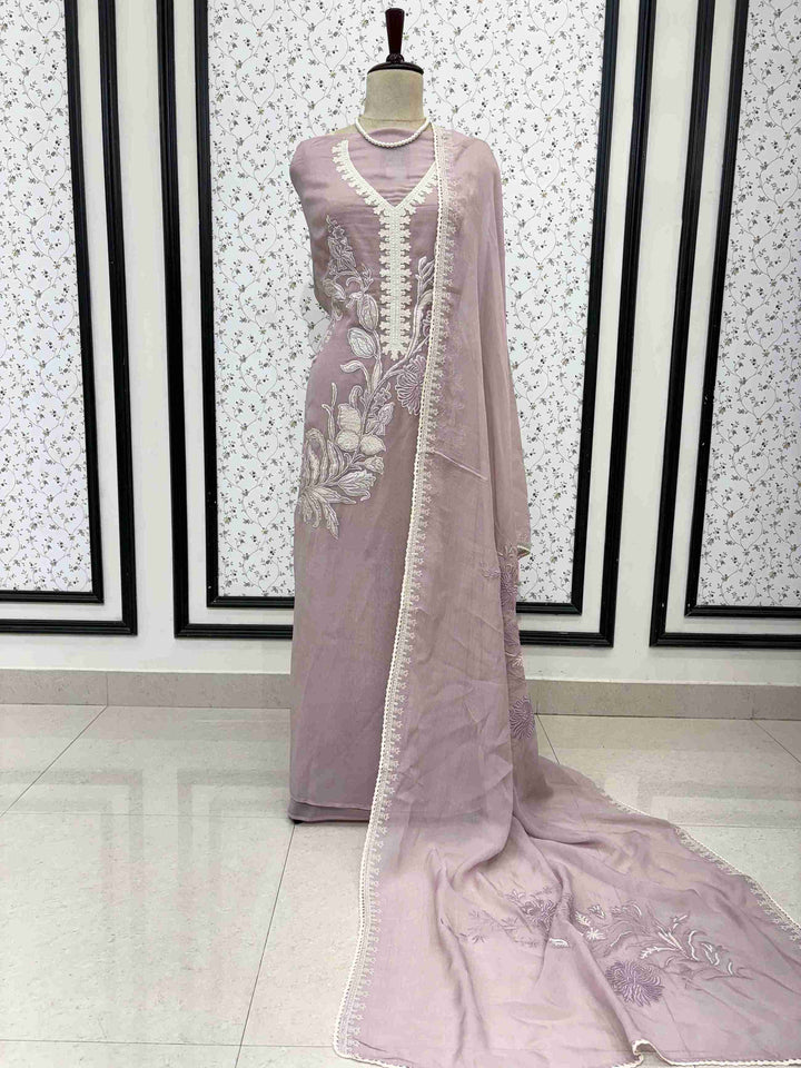 Dusty rose mauve mul cotton unstitched suit full front view with matching applique dupatta draped on mannequin
