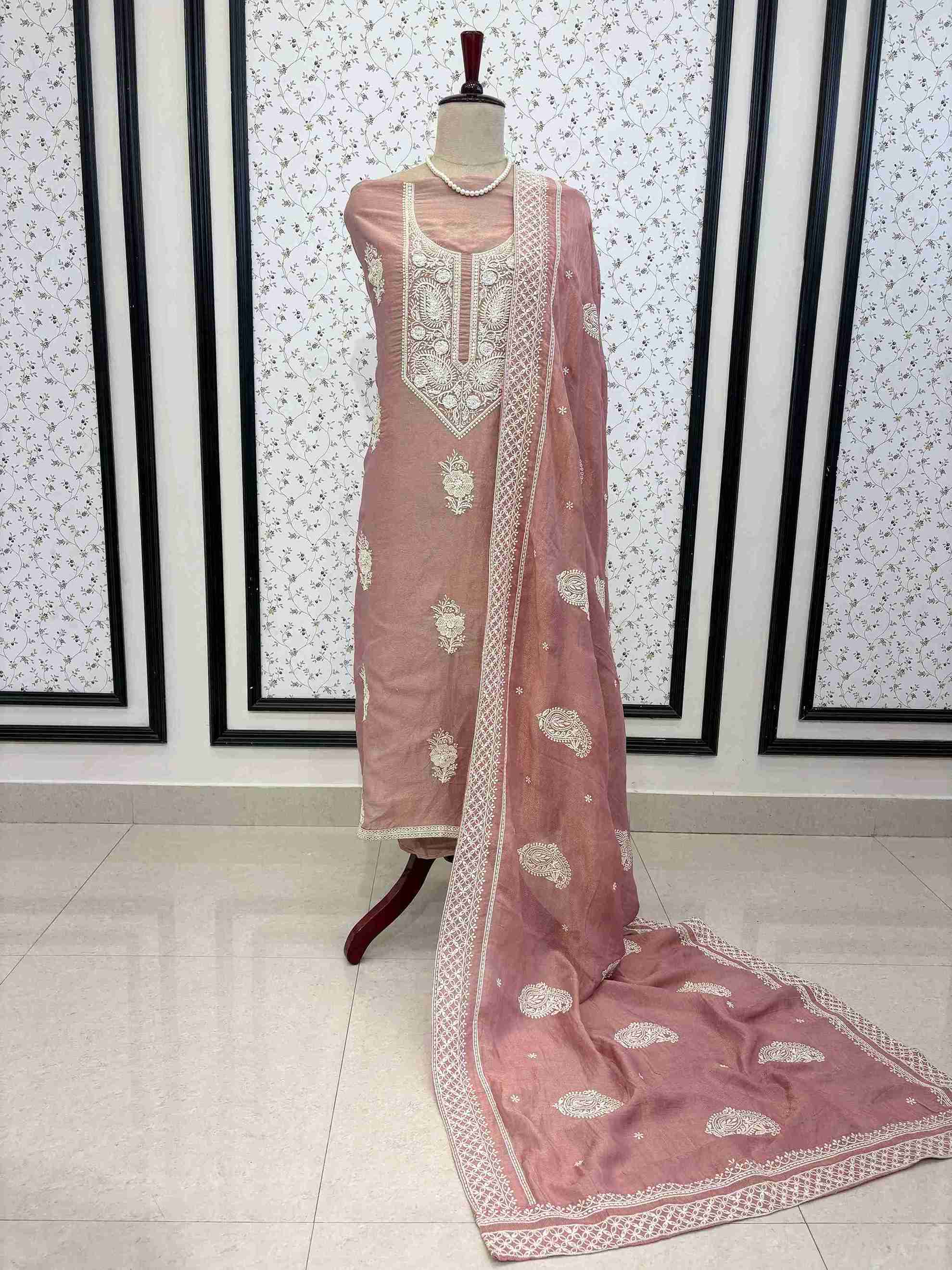 Dusty rose shimmer tissue unstitched suit with white chikankari inspired thread embroidery displayed on mannequin