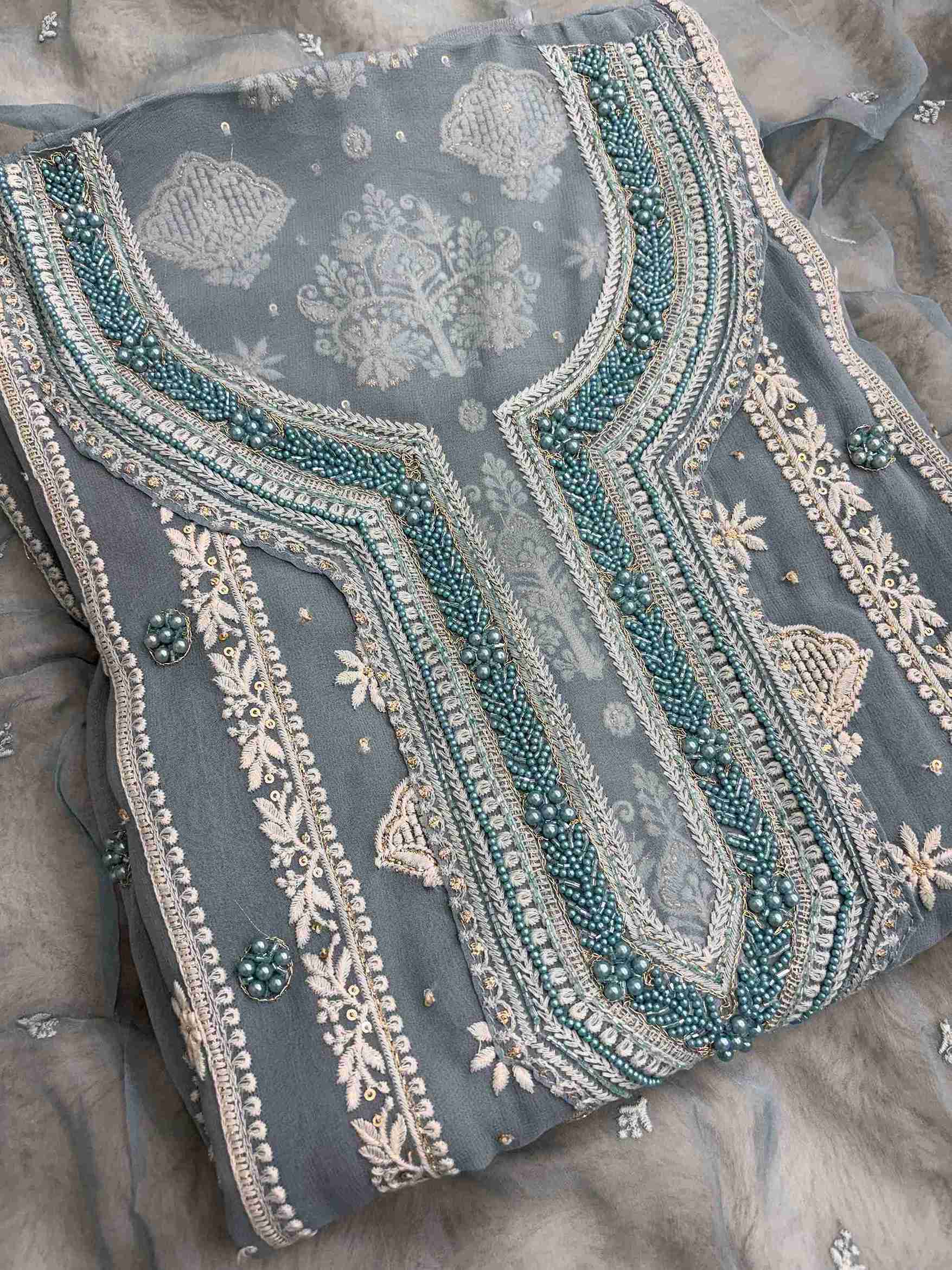Close-up of dusty teal georgette shirt with detailed zari and thread embroidered neckline