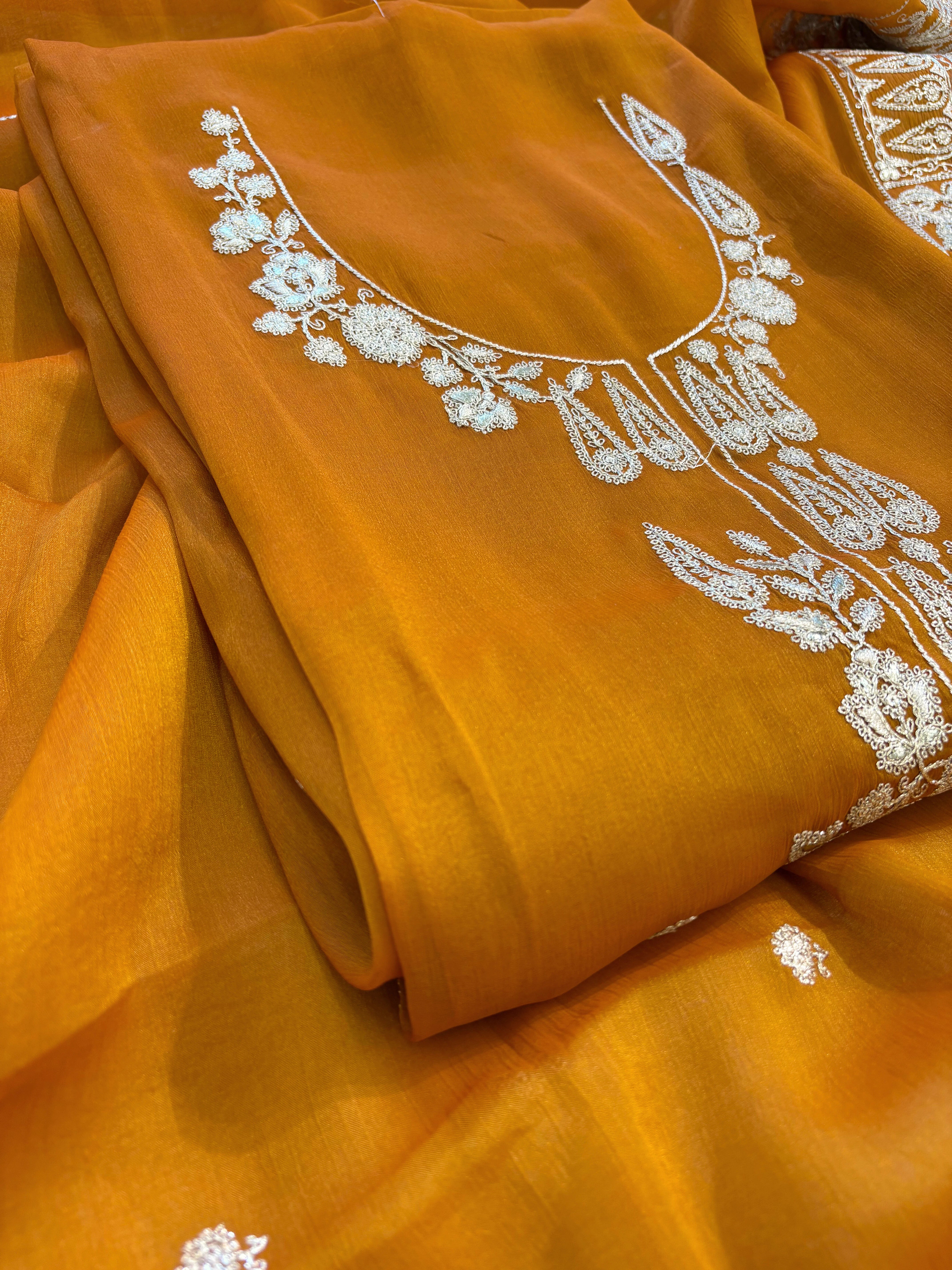 Mustard Yellow organza unstitched suit with golden zari embroidery and embroidered dupatta, ideal for weddings and festive celebrations.