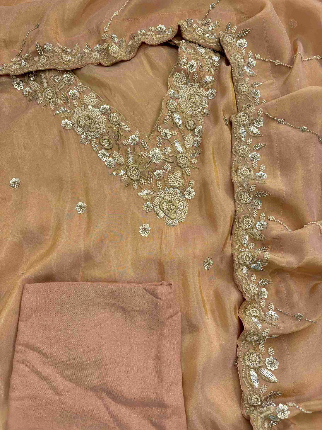 shimmer tissue party wear unstitched suit with dabka cutdana and sequence embellishments.