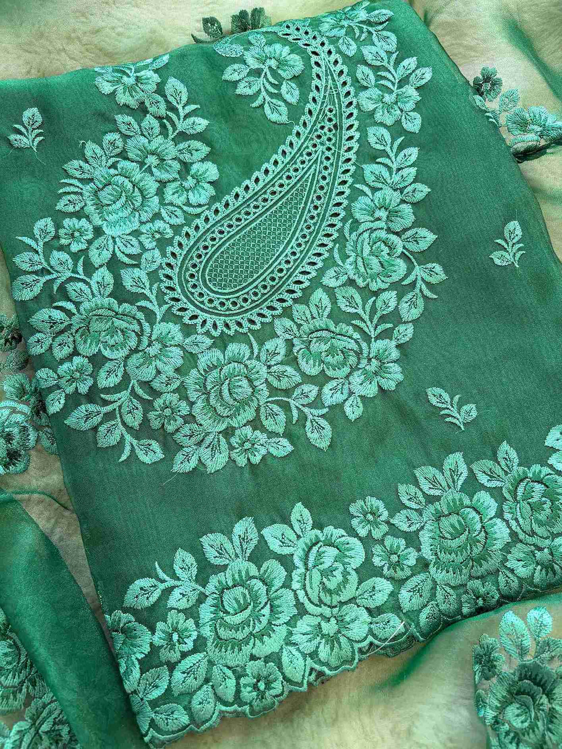Close-up of tone-on-tone floral thread embroidery on glass tissue fabric