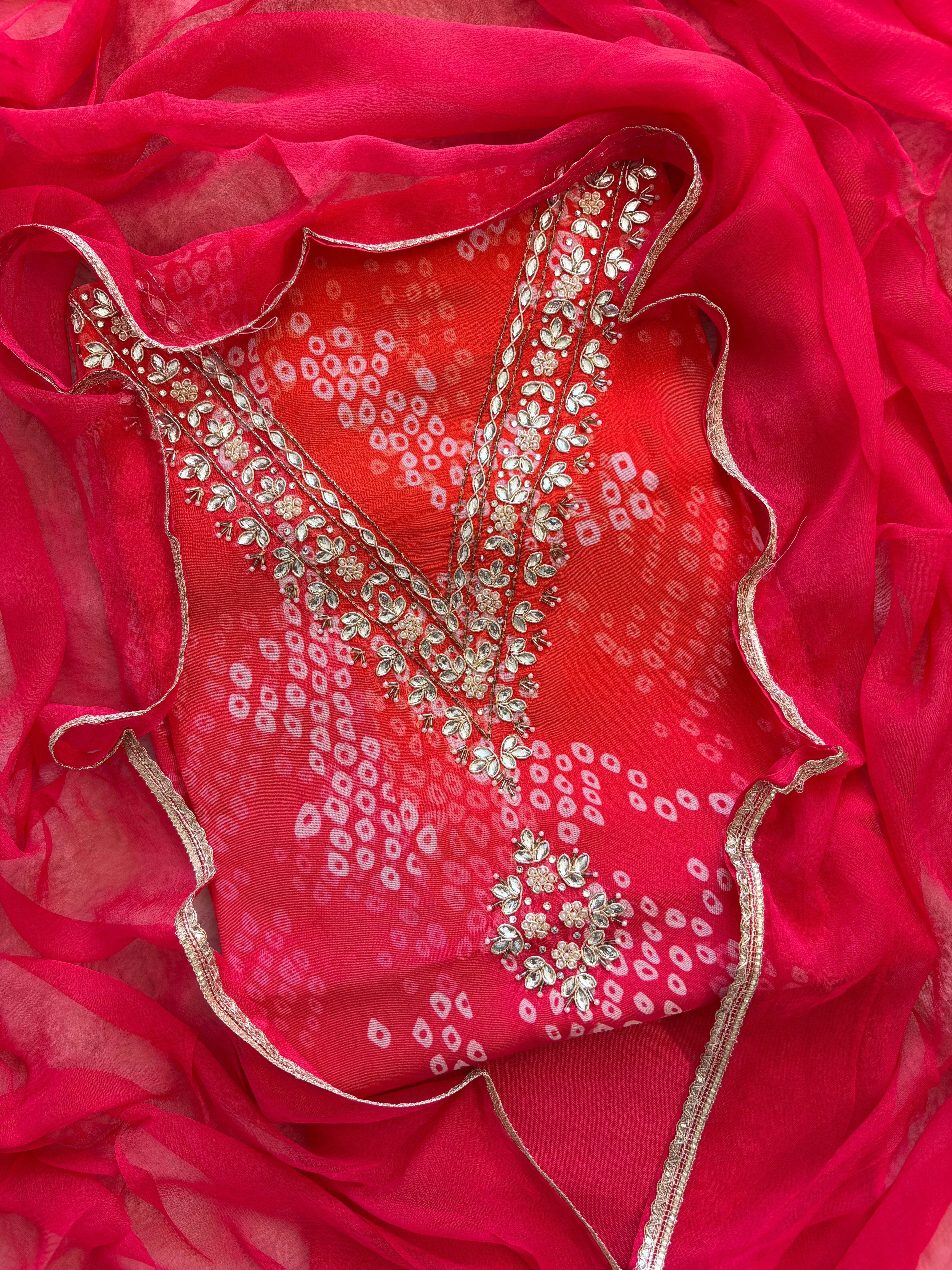Red organza bandhani suit with ombre effect and chiffon dupatta with lace border.