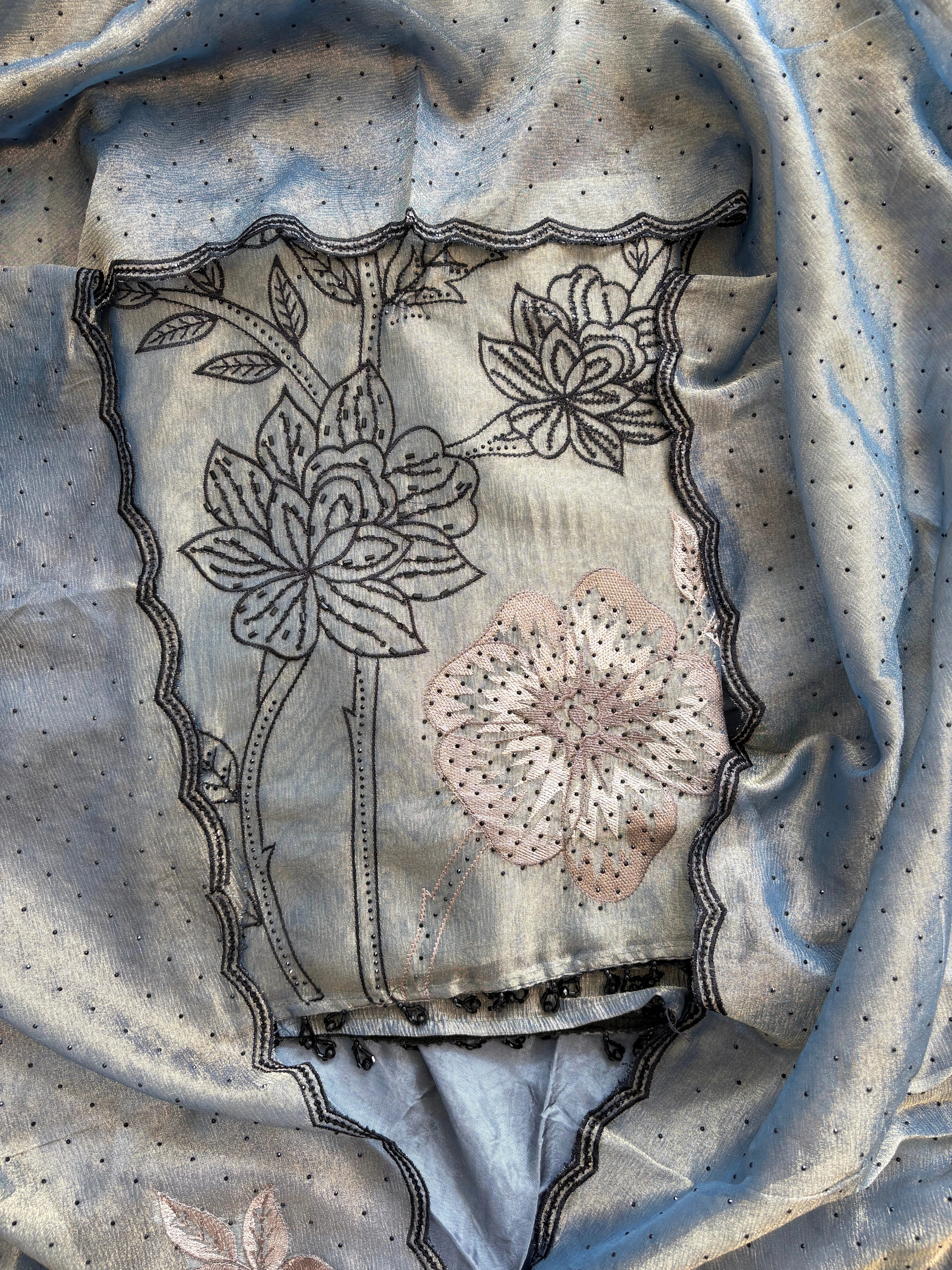 Grey glass tissue suit with intricate embroidery and organza dupatta – luxury ethnic wear for weddings and festive occasions.