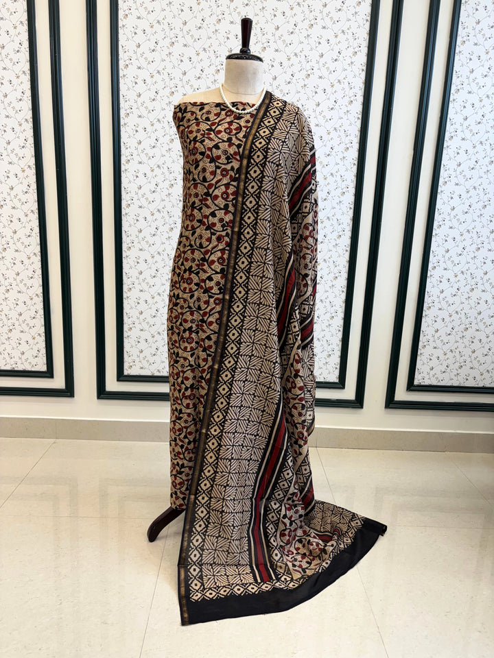 Maheshwari fabric suit with Kalamkari floral print in black, ivory, and maroon tones, featuring traditional hand-block designs and striped dupatta.