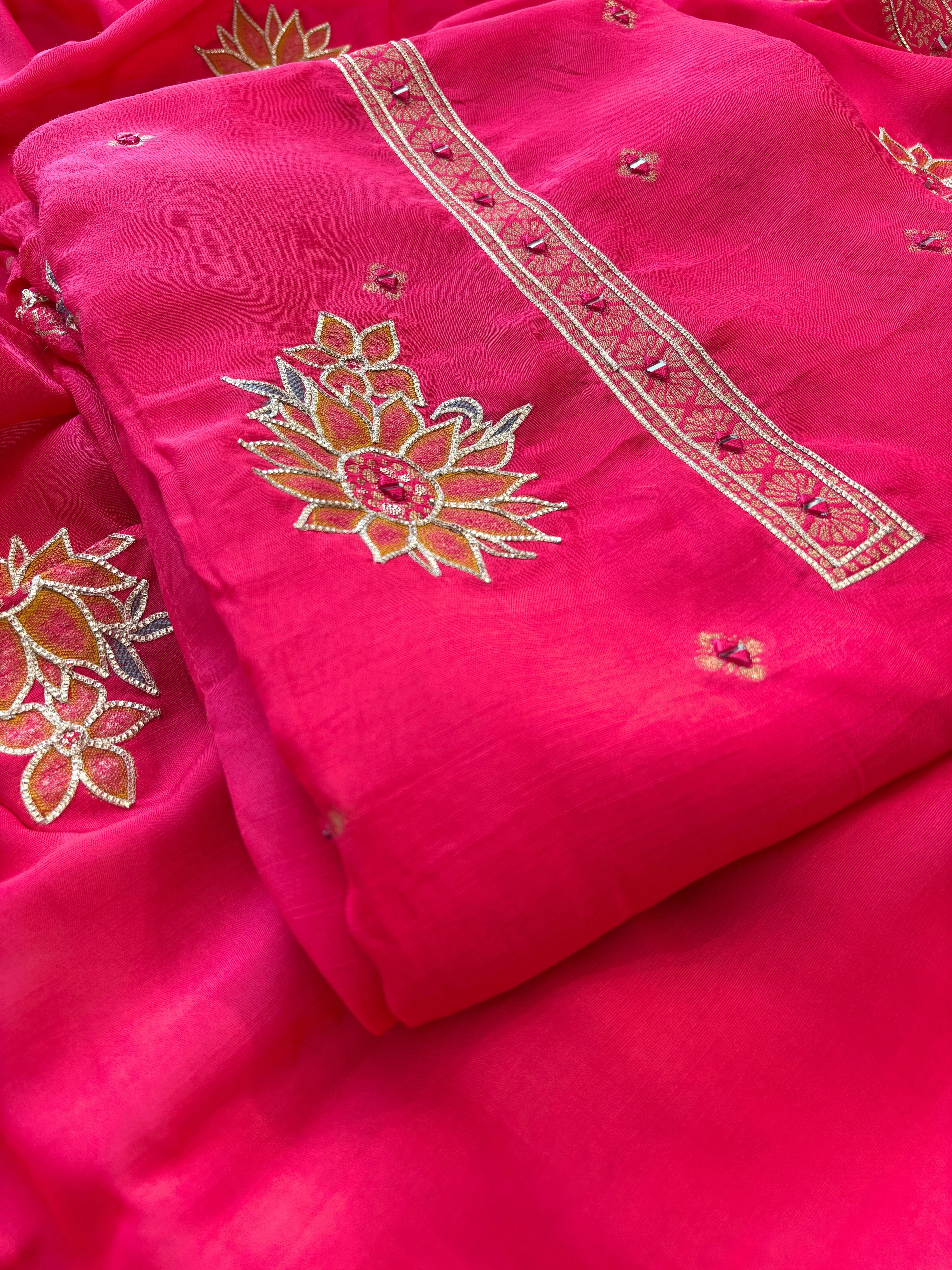 Pink linen suit with mirror work embroidery and applique floral dupatta.