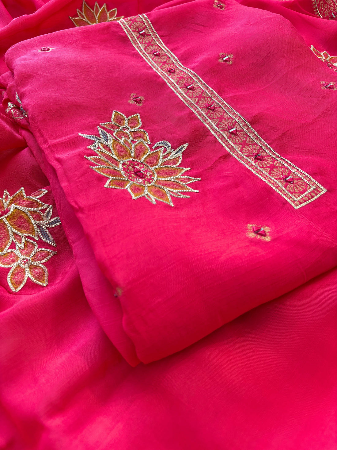 Pink linen suit with mirror work embroidery and applique floral dupatta.