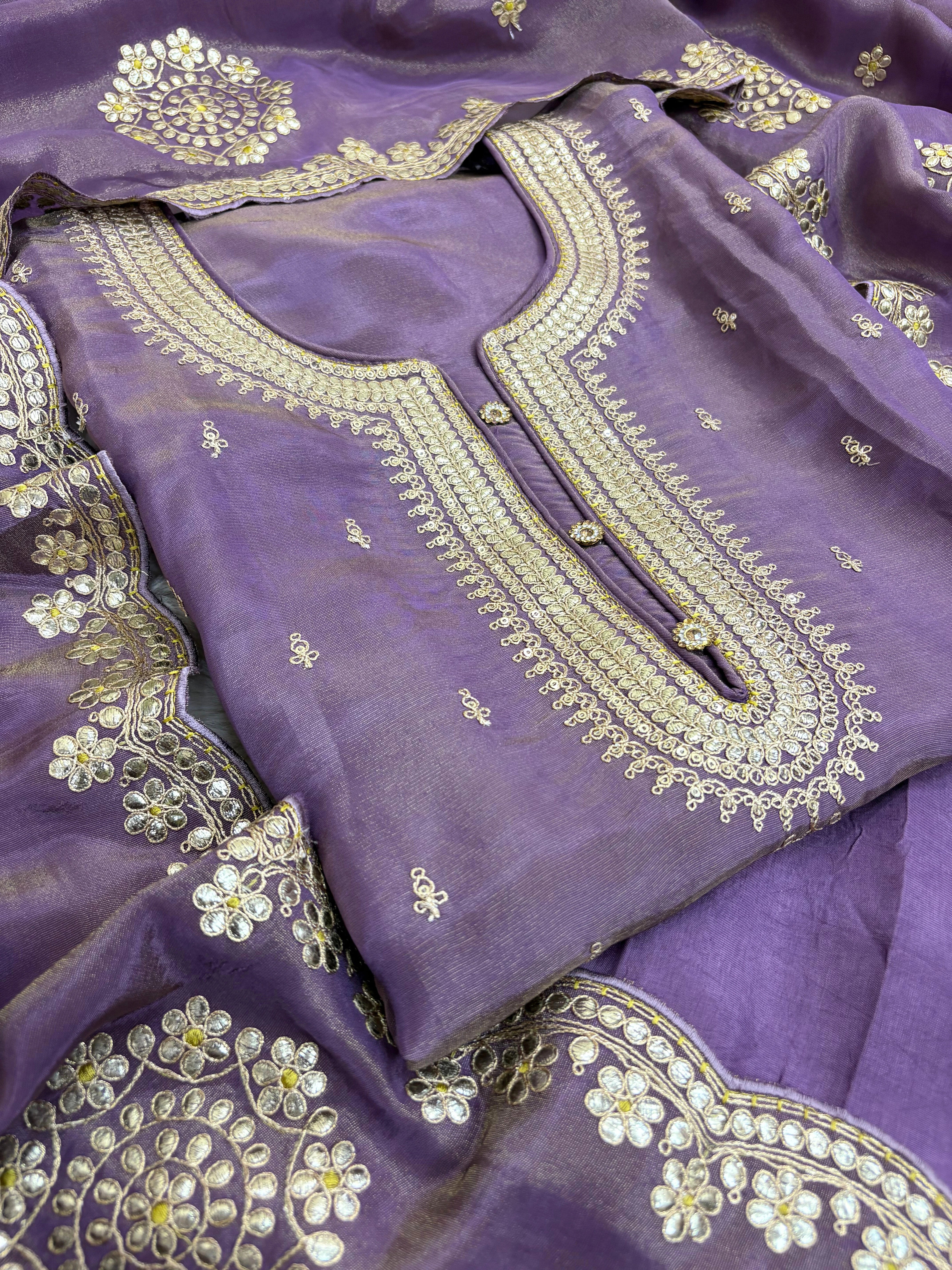 Royal purple silk unstitched suit with golden zari embroidery, sequins, floral motifs, and embroidered dupatta – perfect for weddings and festive wear