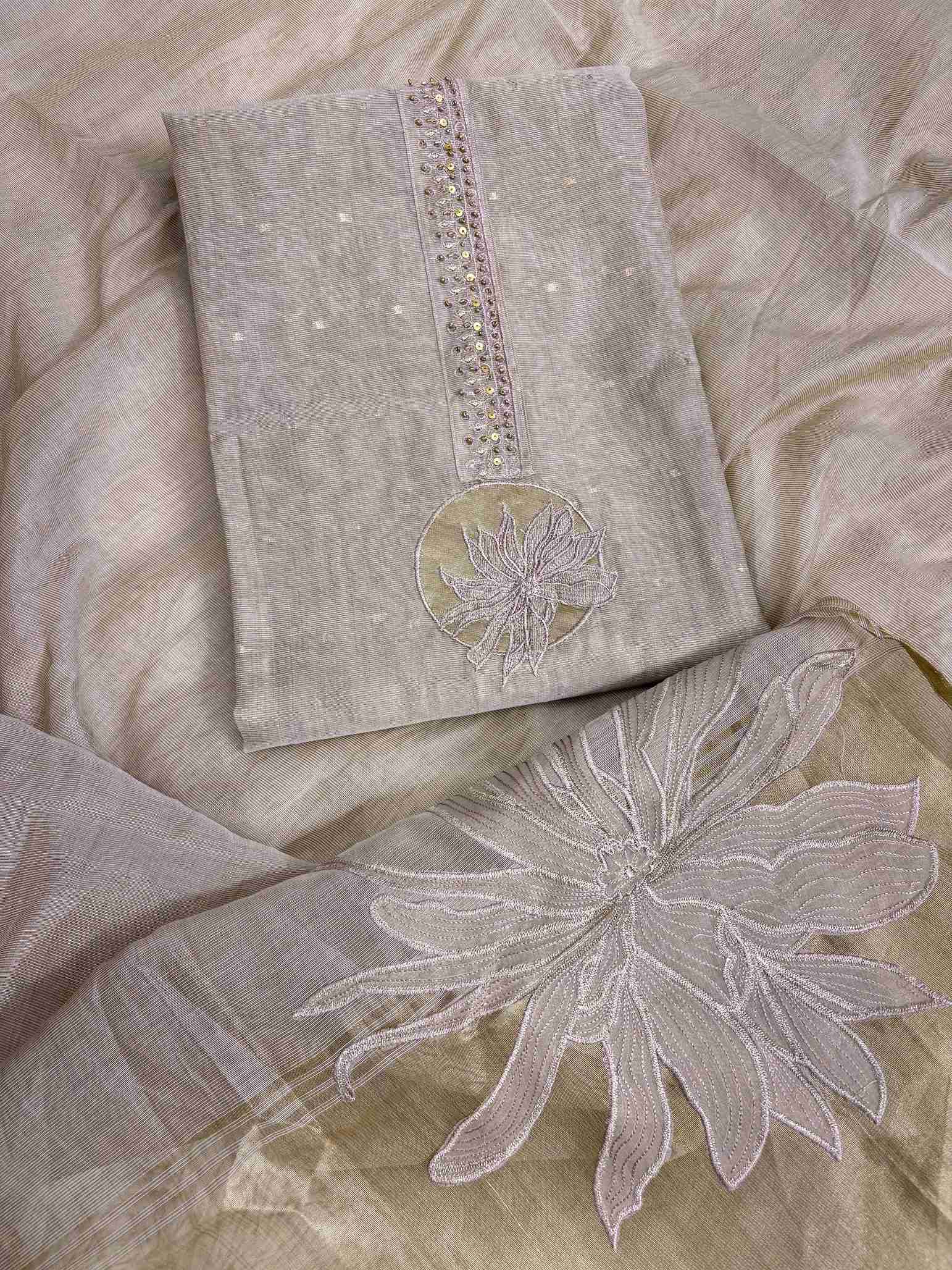 flat lay of rose gold jaamdani suit with floral applique highlight