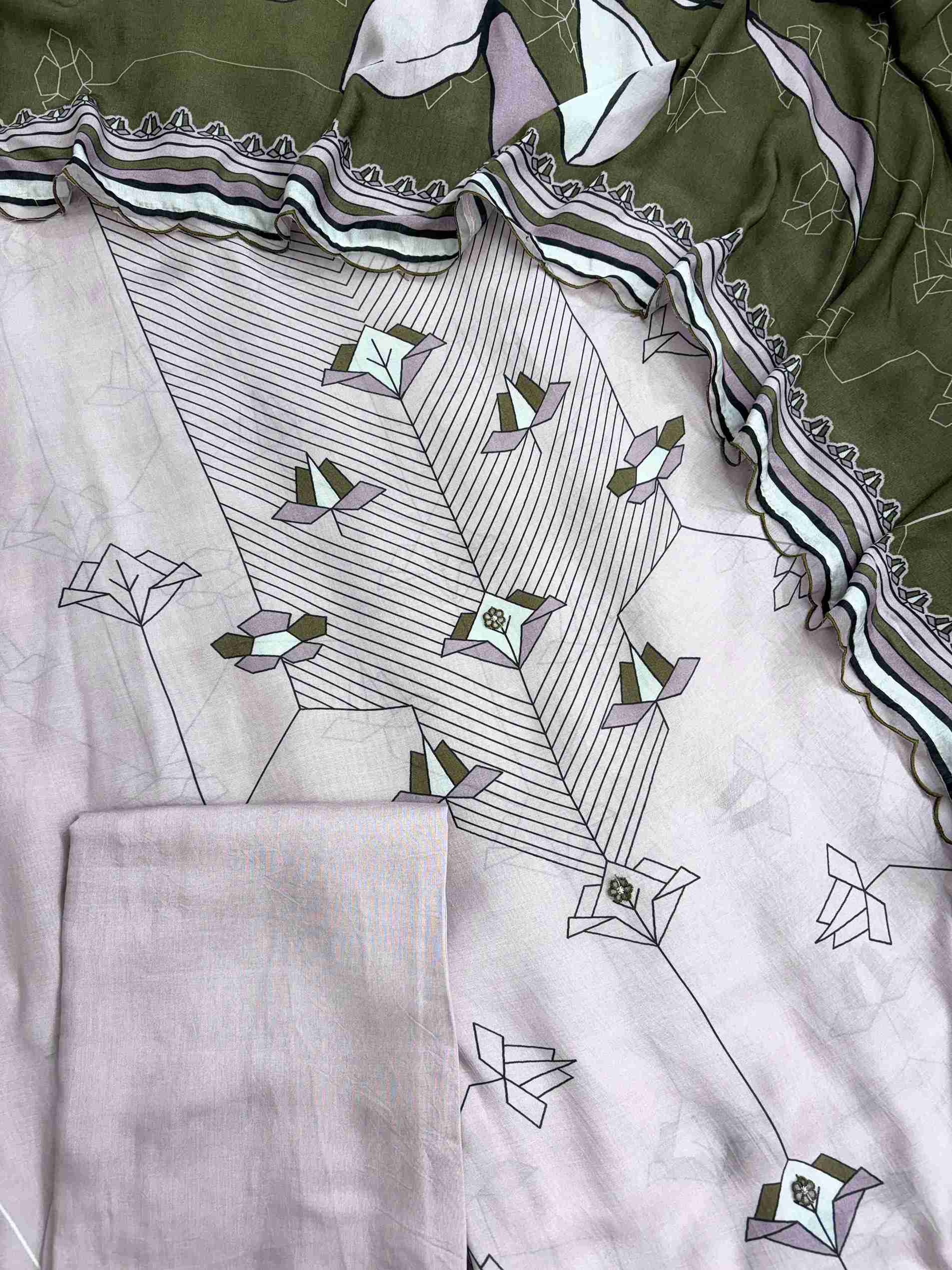 Tiny embroidered floral applique detailing along the center panel of muslin shirt