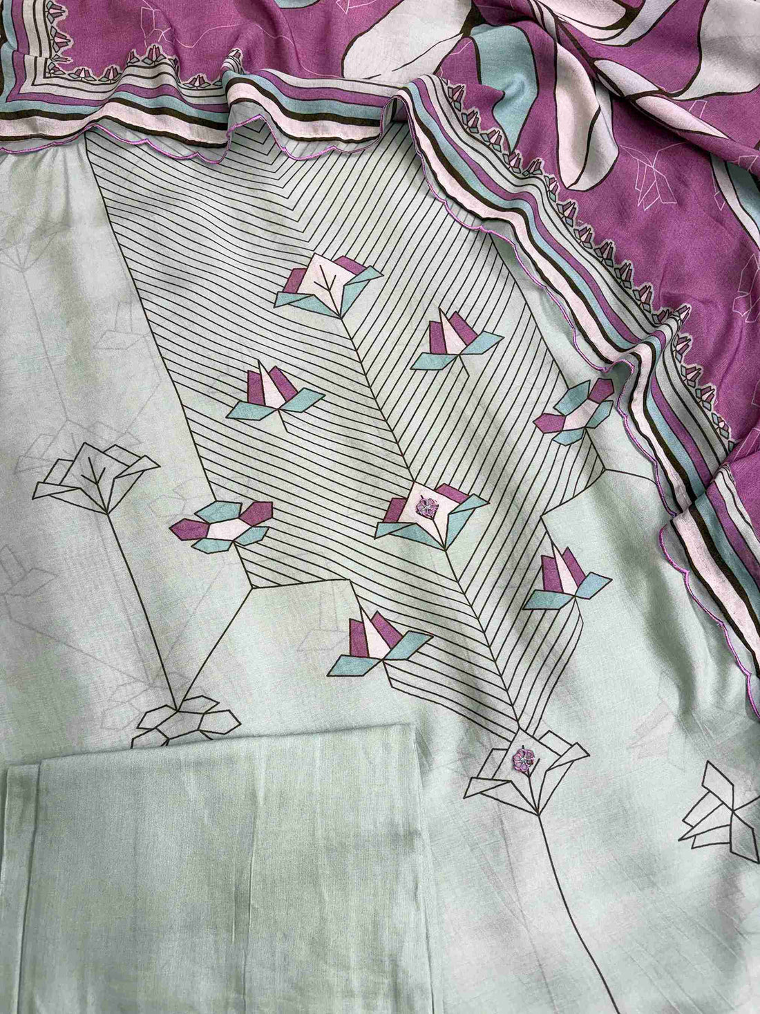 Tiny embroidered floral applique detailing along the center panel of muslin shirt