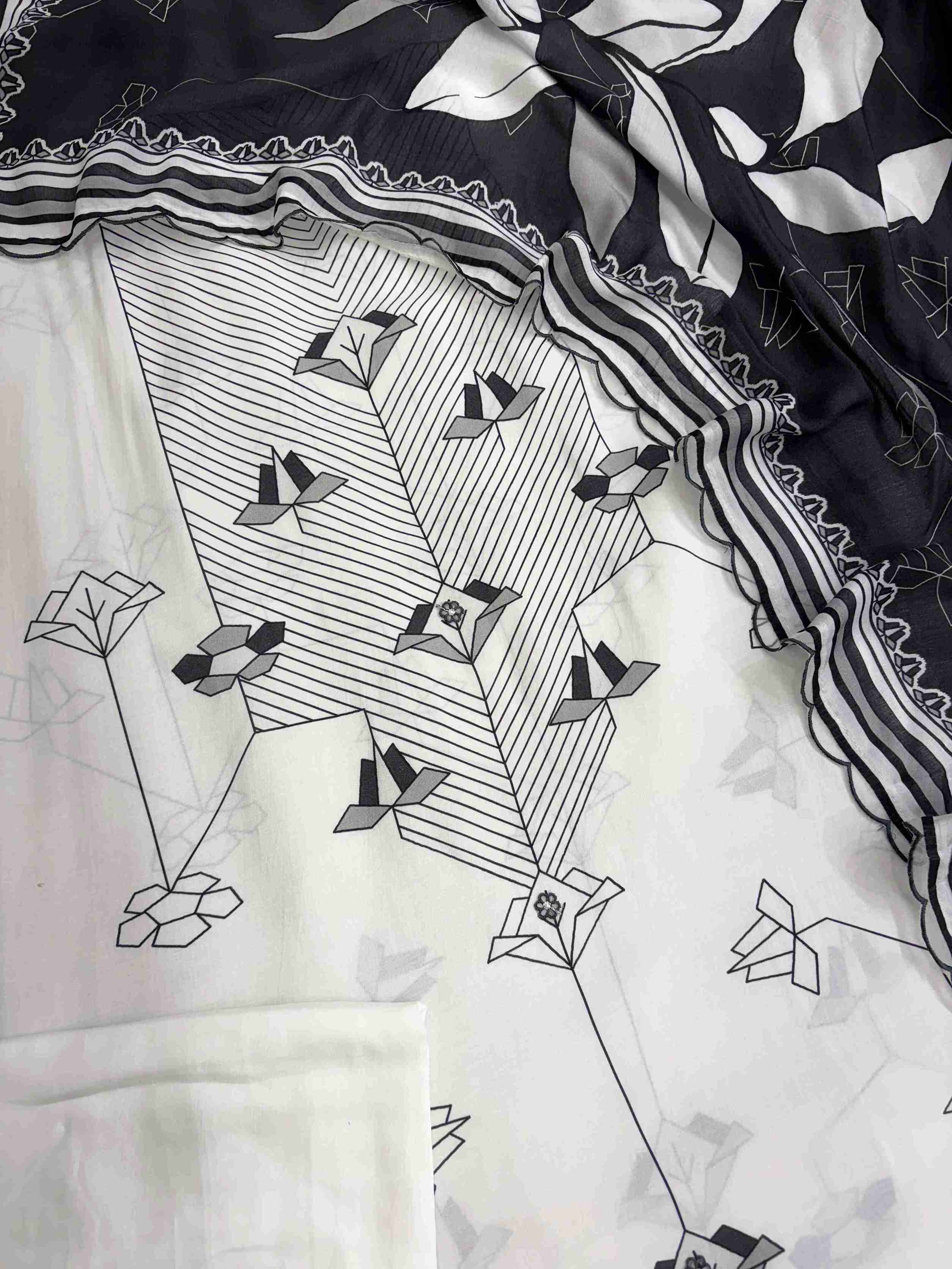 Tiny embroidered floral applique detailing along the center panel of muslin shirt