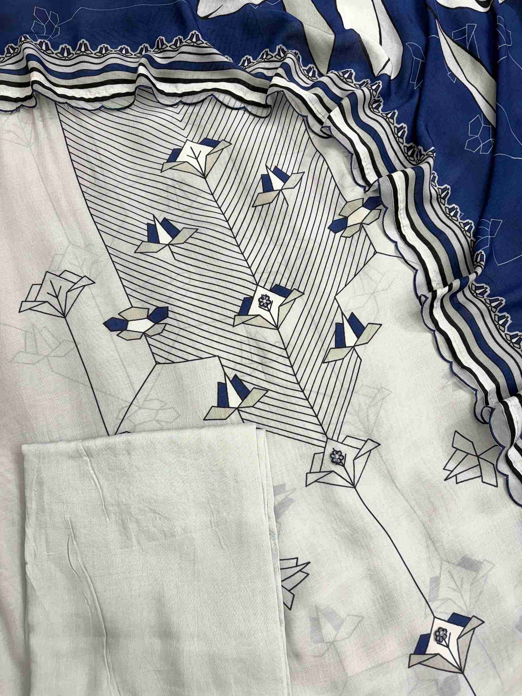 Tiny embroidered floral applique detailing along the center panel of muslin shirt