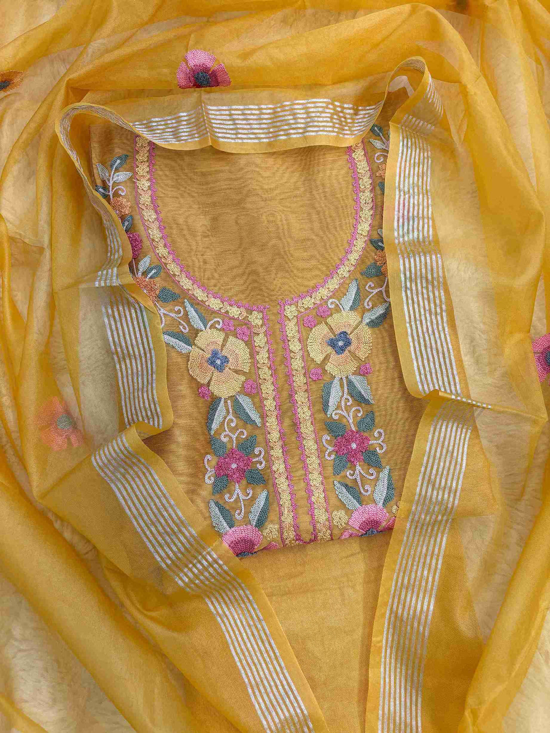 Large floral motif and embroidered border on golden yellow Chanderi suit hemline