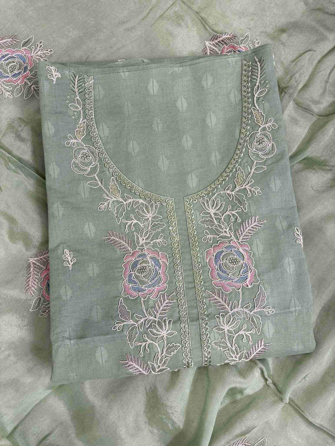Floral embroidered booti detail on green cotton unstitched suit