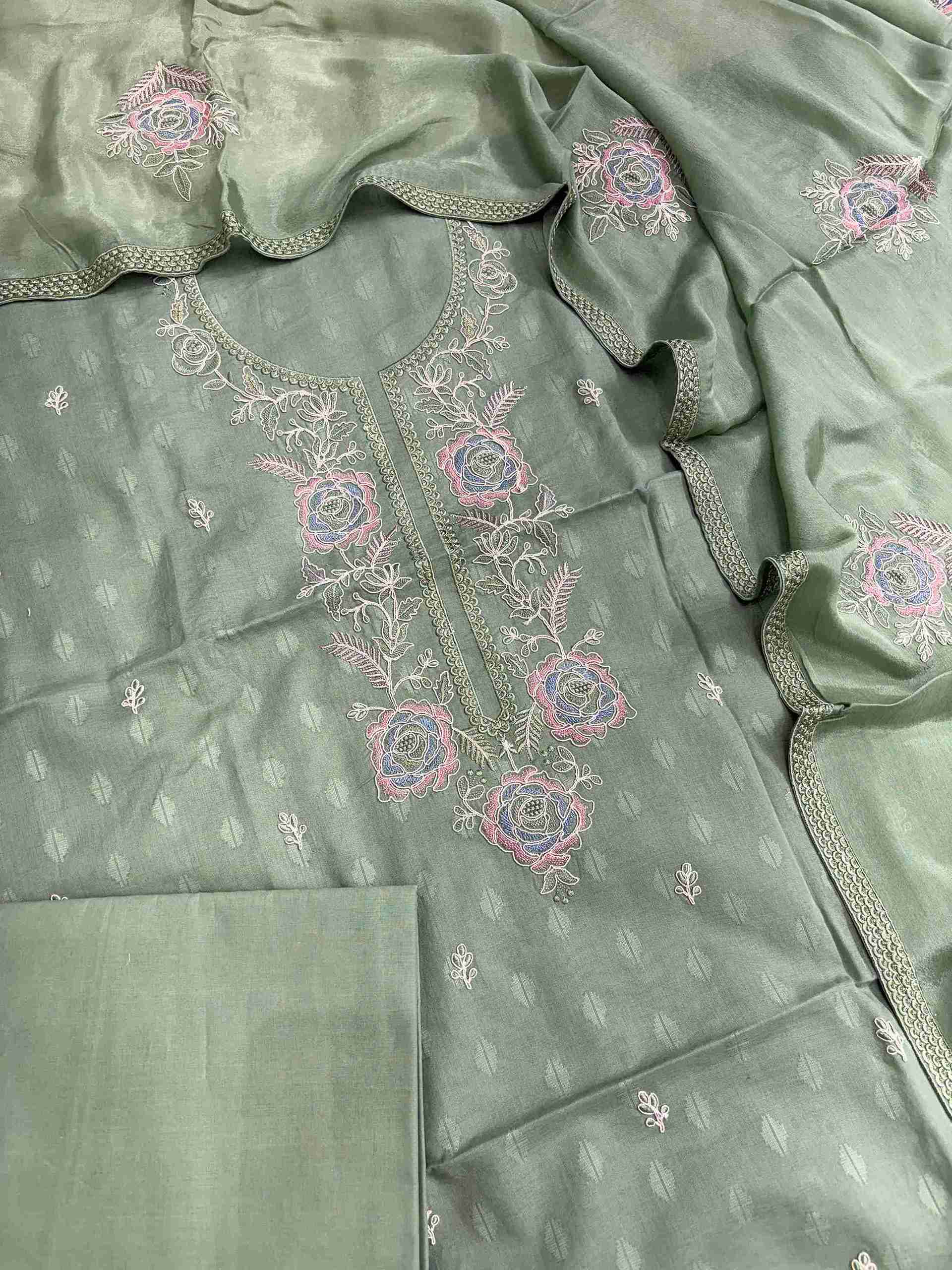Close-up of floral rose embroidery on green cotton suit neckline