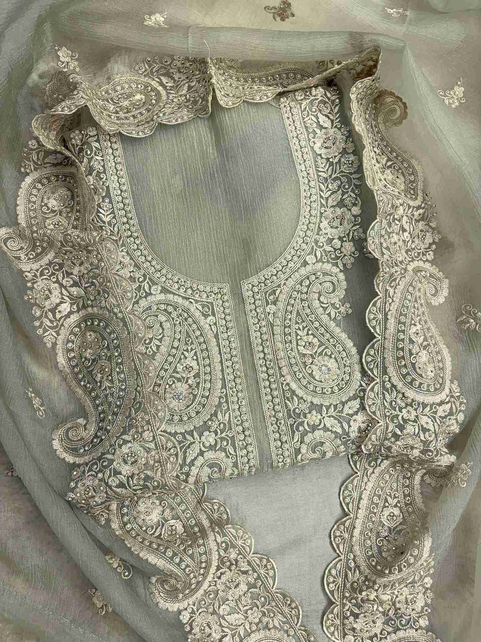 Close-up of intricate paisley neckline with cutdana, sequins, and pearl embellishments on Green marble chiffon shirt