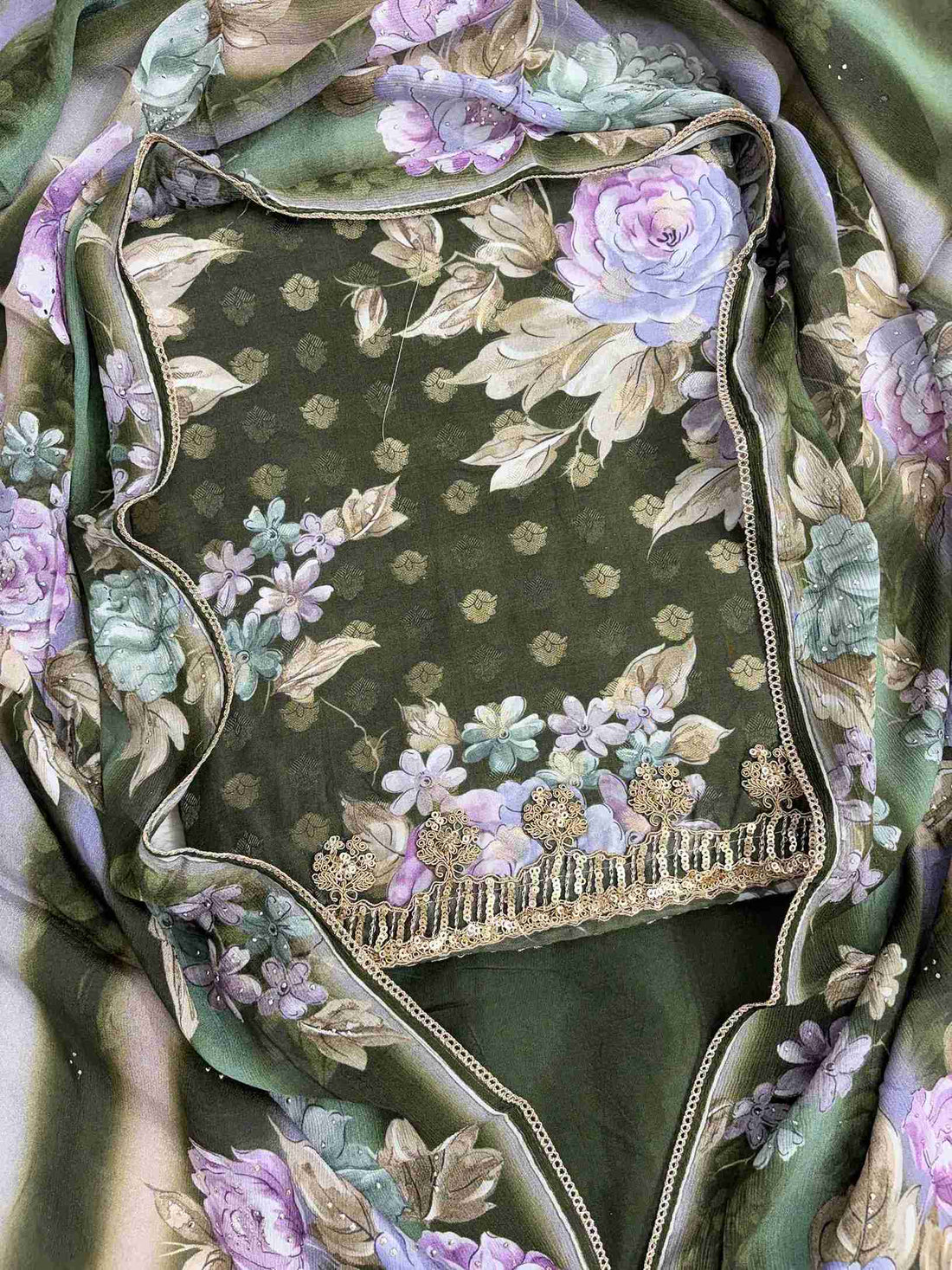 Close-up of all-over digital floral print in contrasting colors on green muslin shirt
