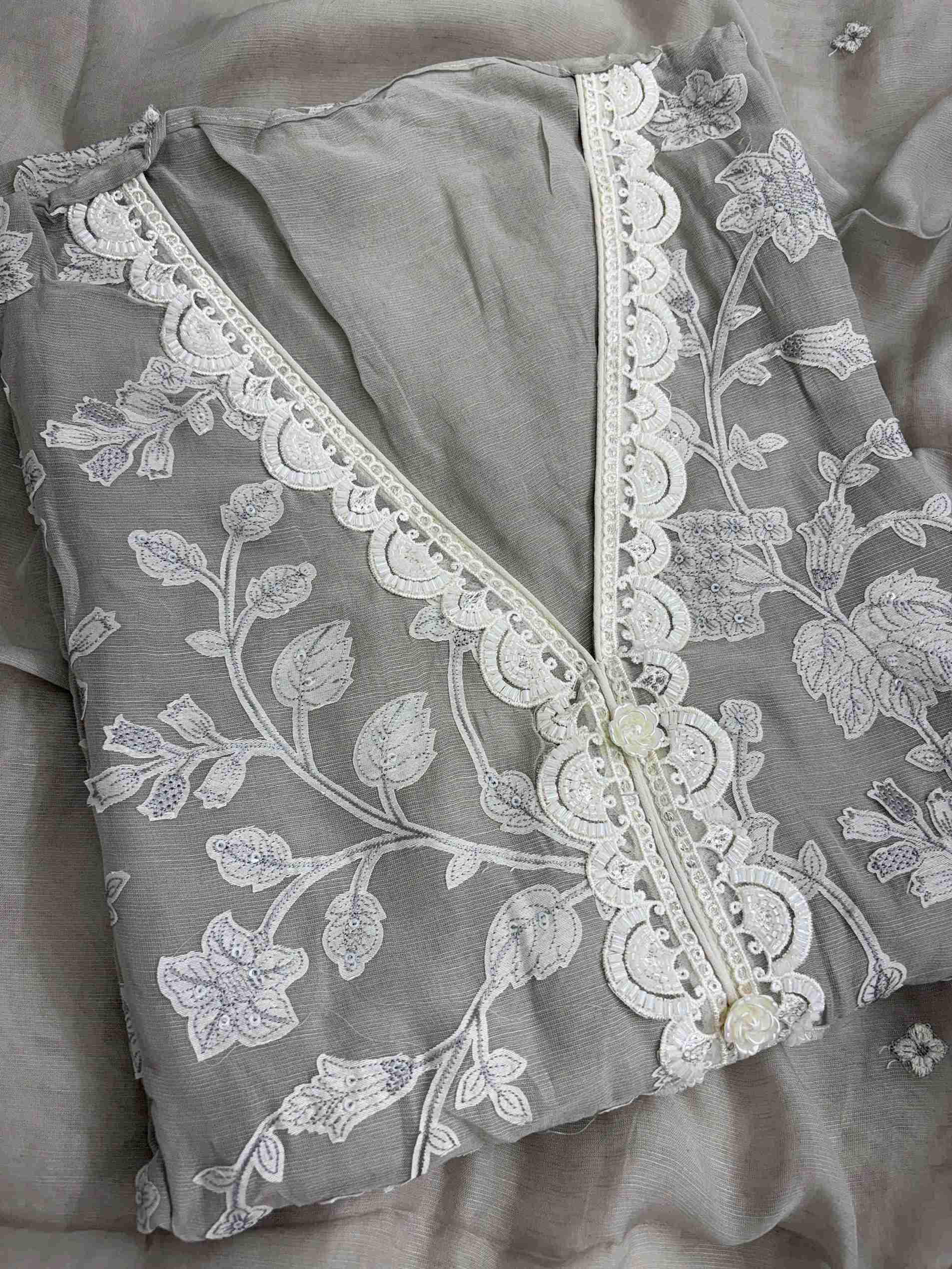 V-neckline detail with cutdana and bead embellishment on grey linen shirt