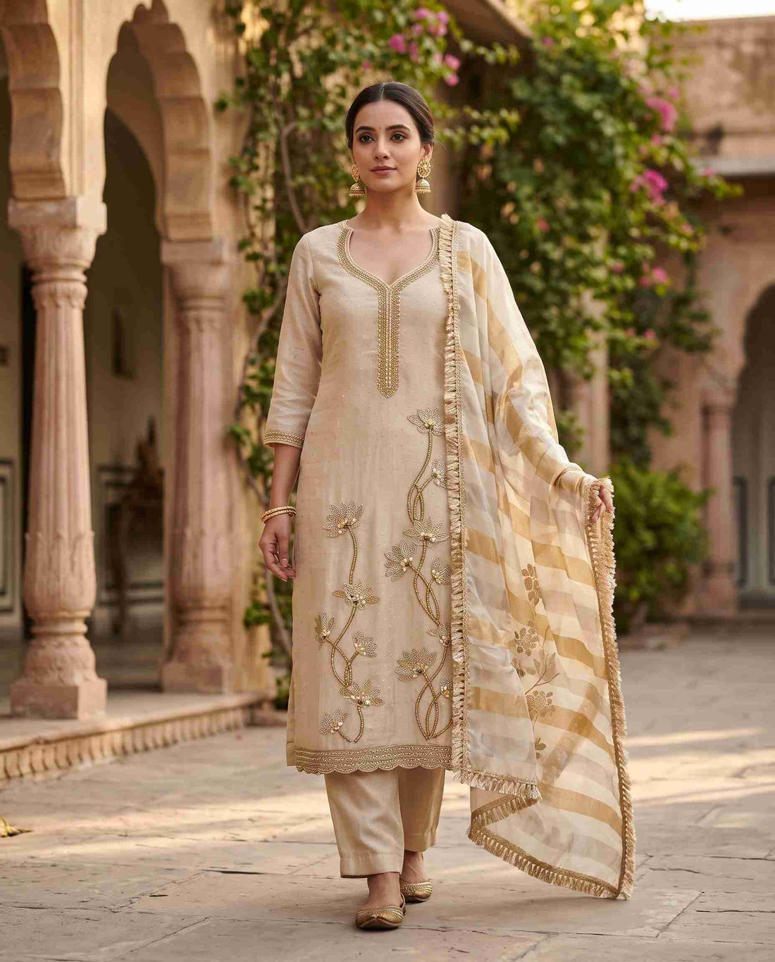 Champagne beige shimmer organza unstitched suit with cutdana and mirror work hemline and striped dupatta