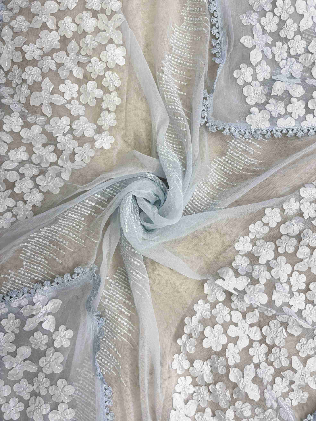 White floral applique on longer sides and four-sided lace finishing on ice blue chiffon dupatta