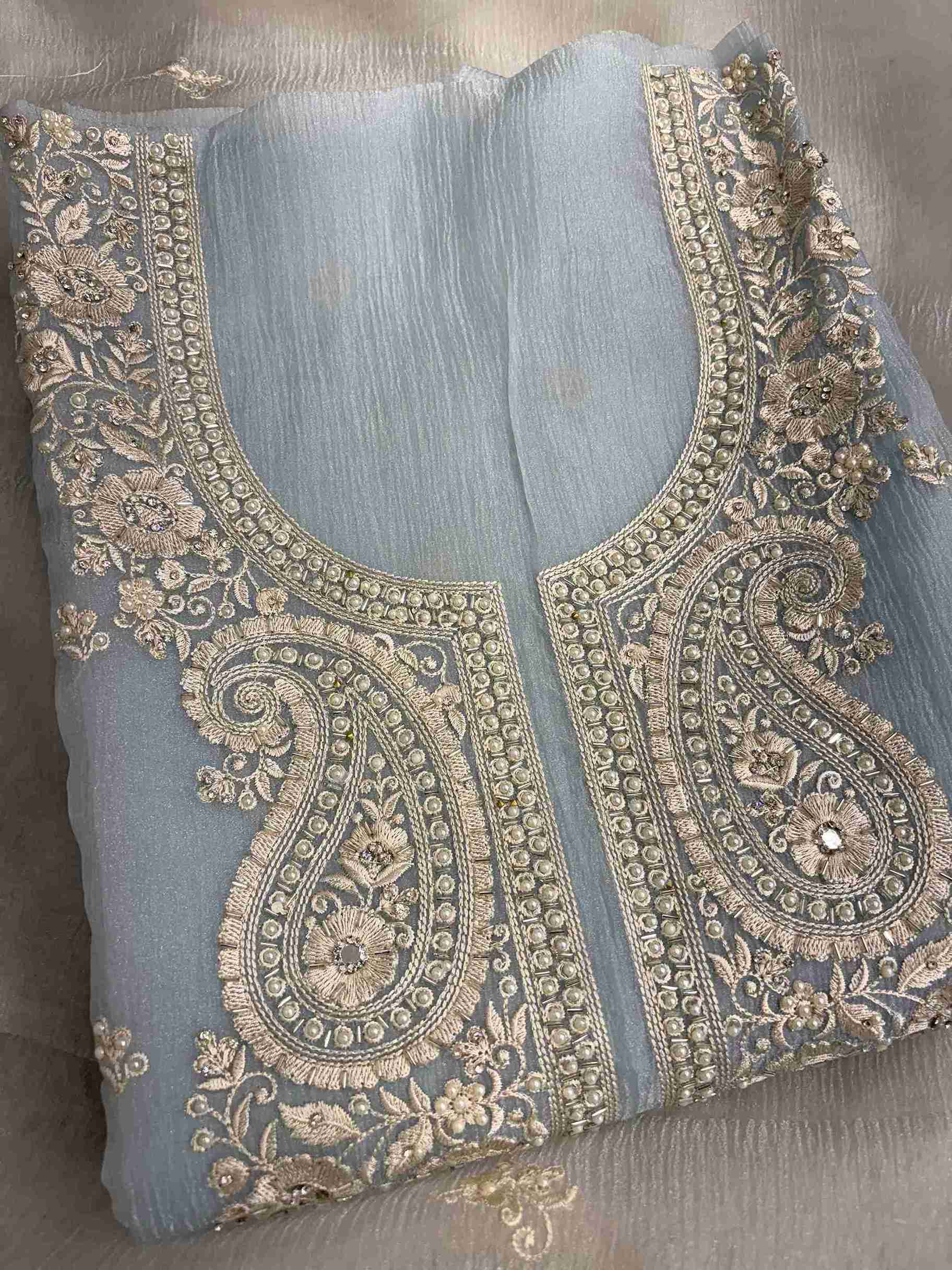 Paisley motifs detail across the neckline of ice blue marble chiffon shirt