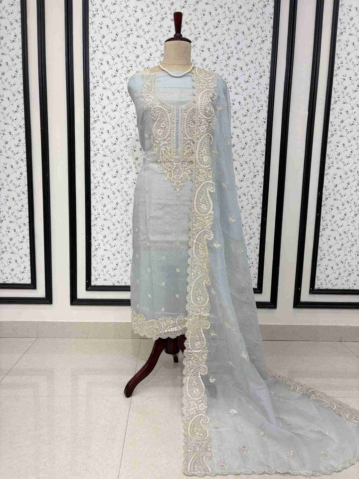 Ice blue marble chiffon unstitched suit full front view with paisley cutwork dupatta draped on mannequin