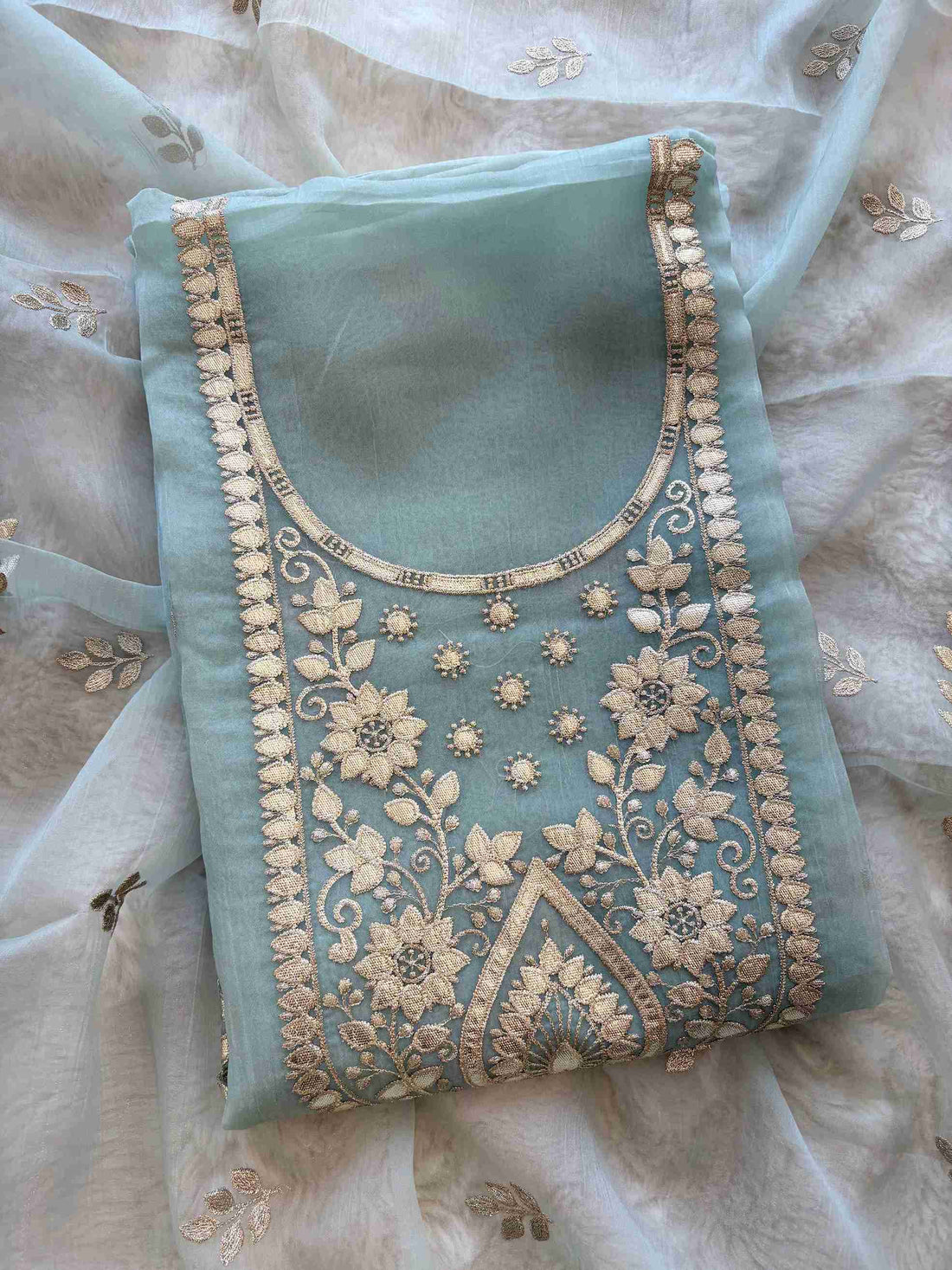 Close-up of leather gota work neckline on ice blue shimmer tissue suit