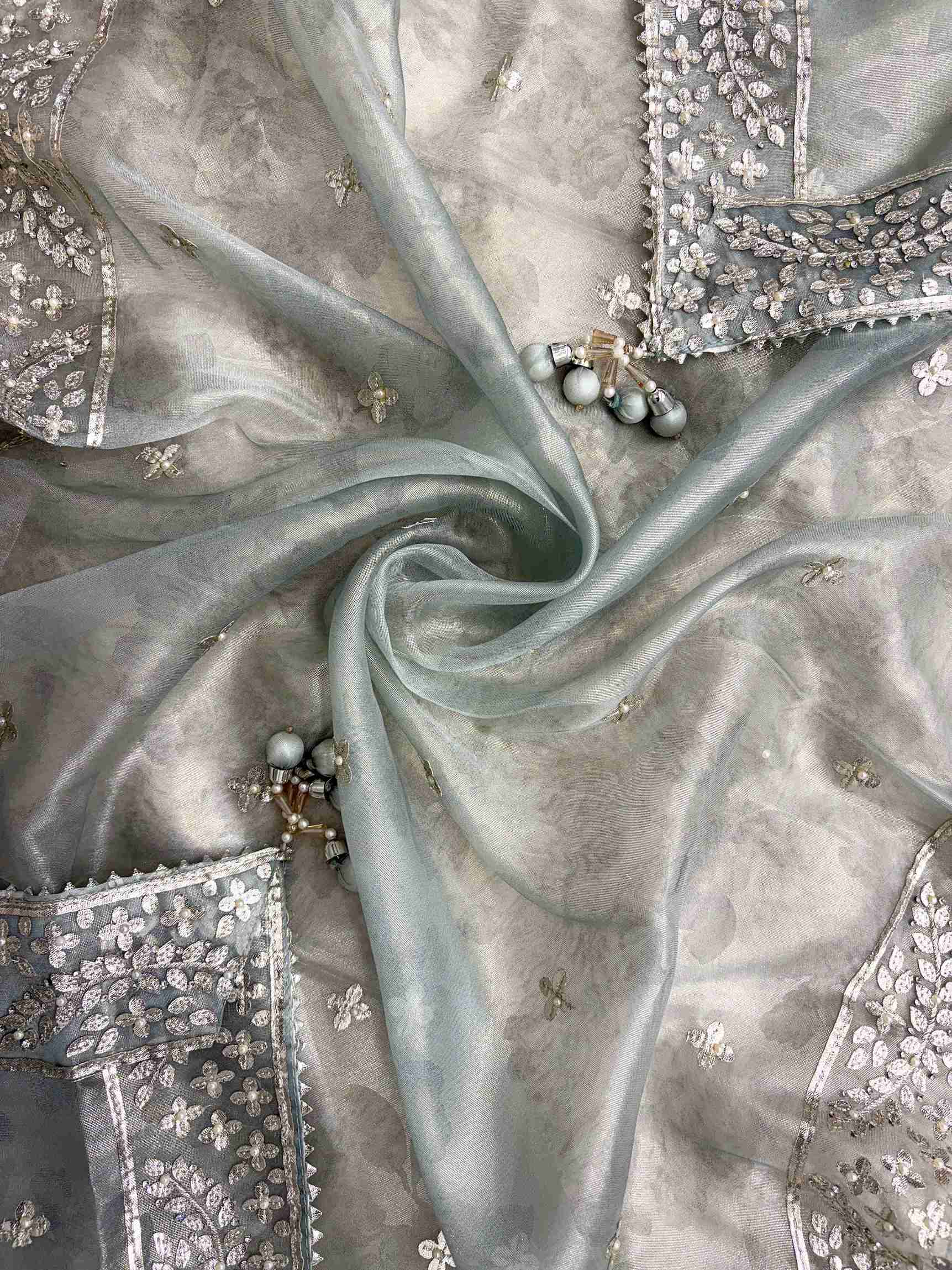 Scattered silver gota motifs across dupatta surface with gota borders on all four sides of Ice blue tissue dupatta