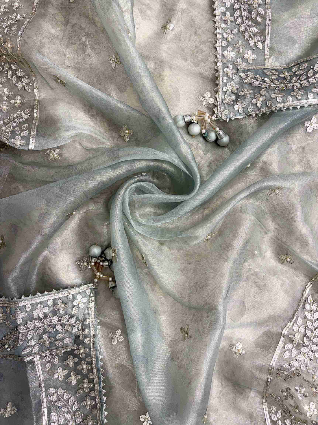 Scattered silver gota motifs across dupatta surface with gota borders on all four sides of Ice blue tissue dupatta