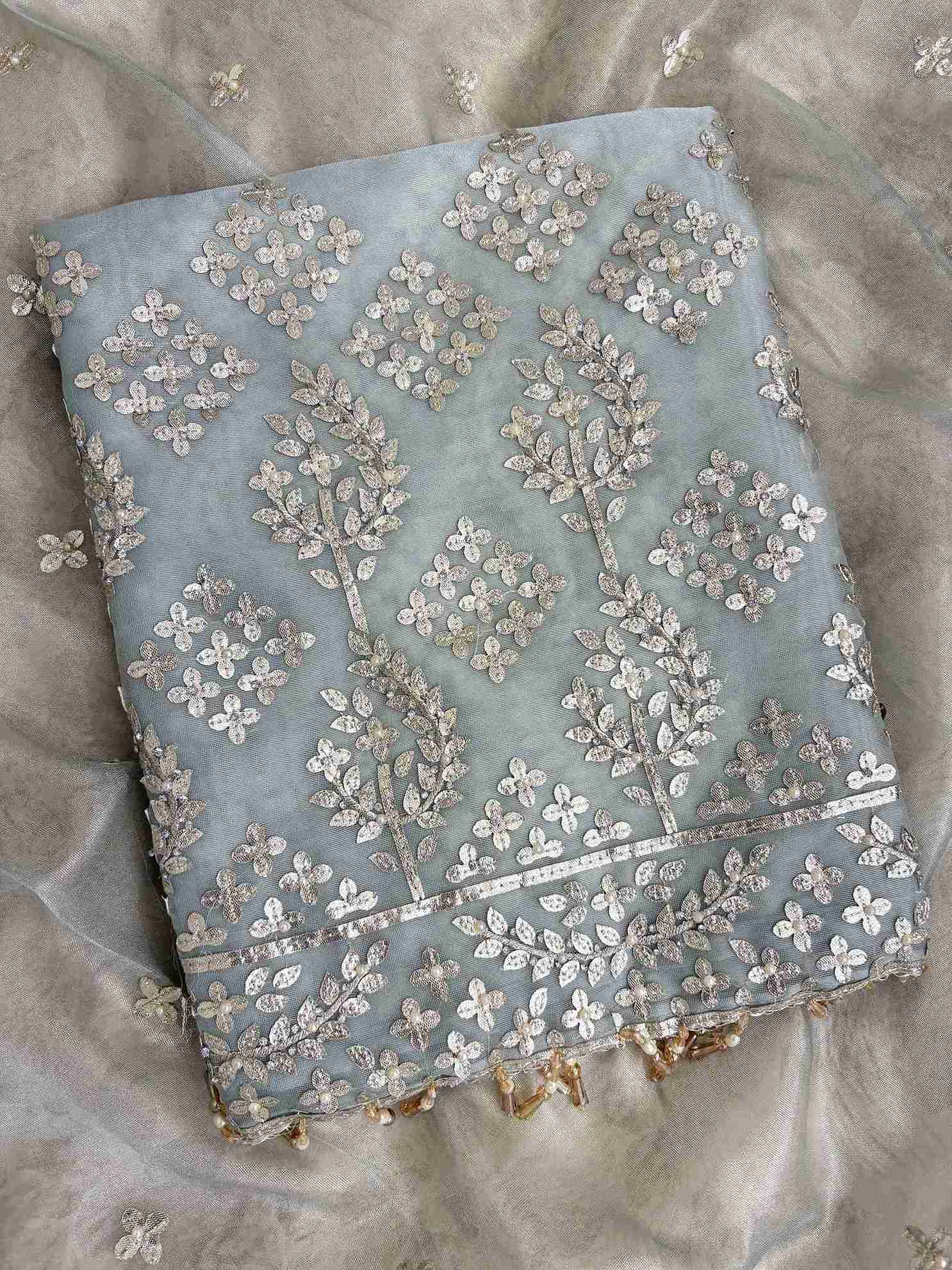 Broad silver gota border at hemline of Ice blue tissue unstitched shirt