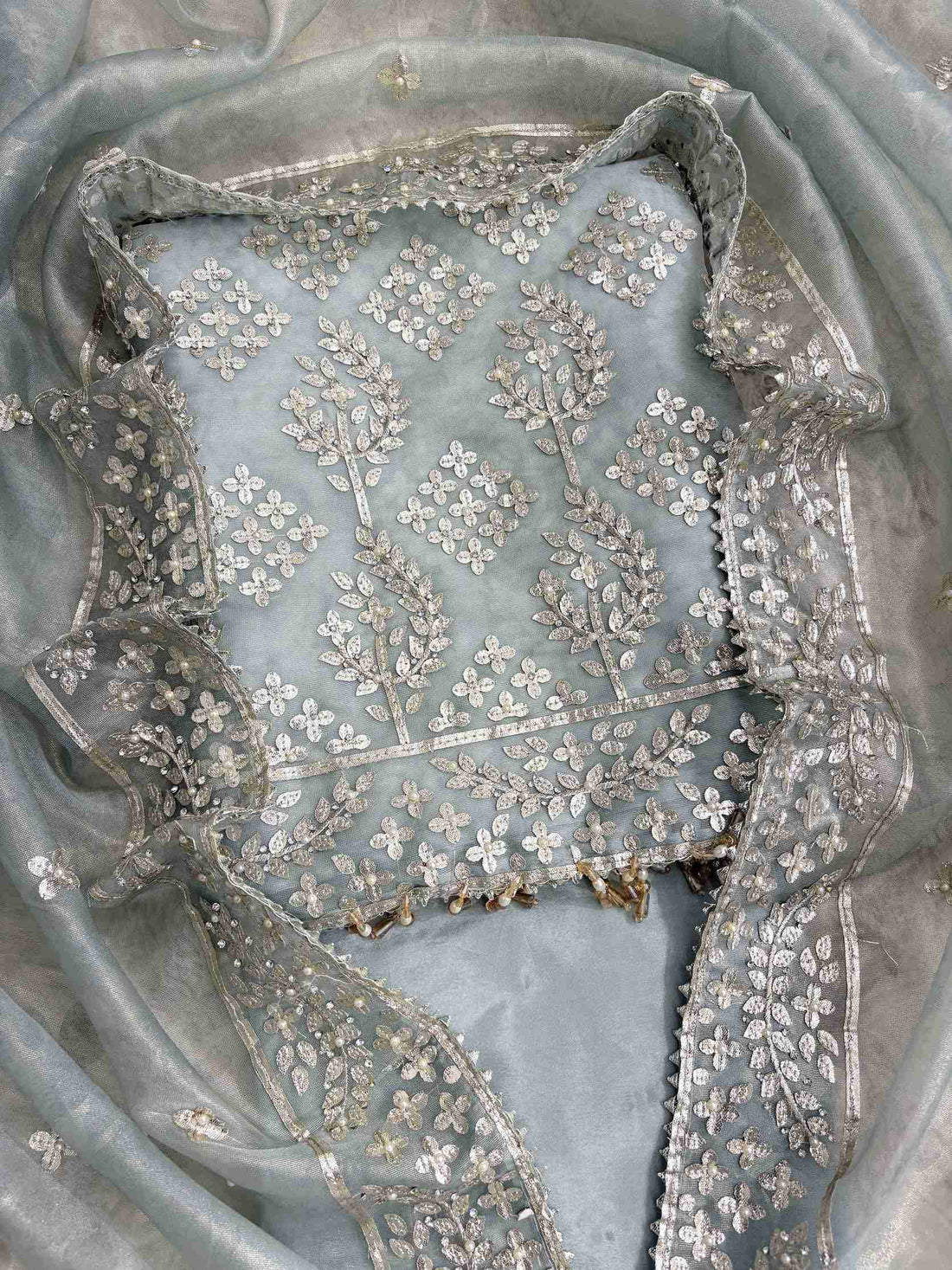 Scattered silver gota motifs across the full body of Ice blue tissue unstitched shirt
